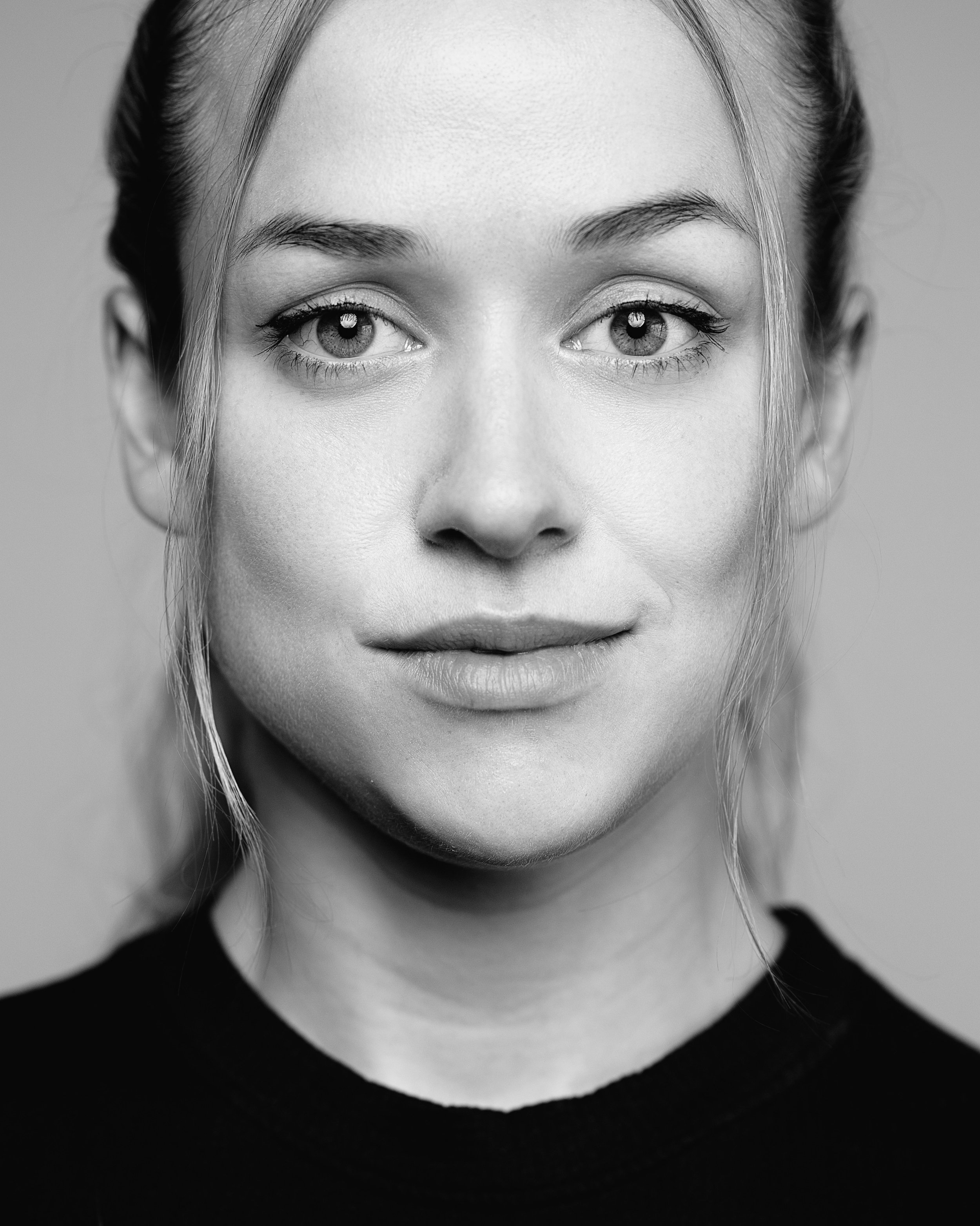 Black and white headshot of female actor black shirt