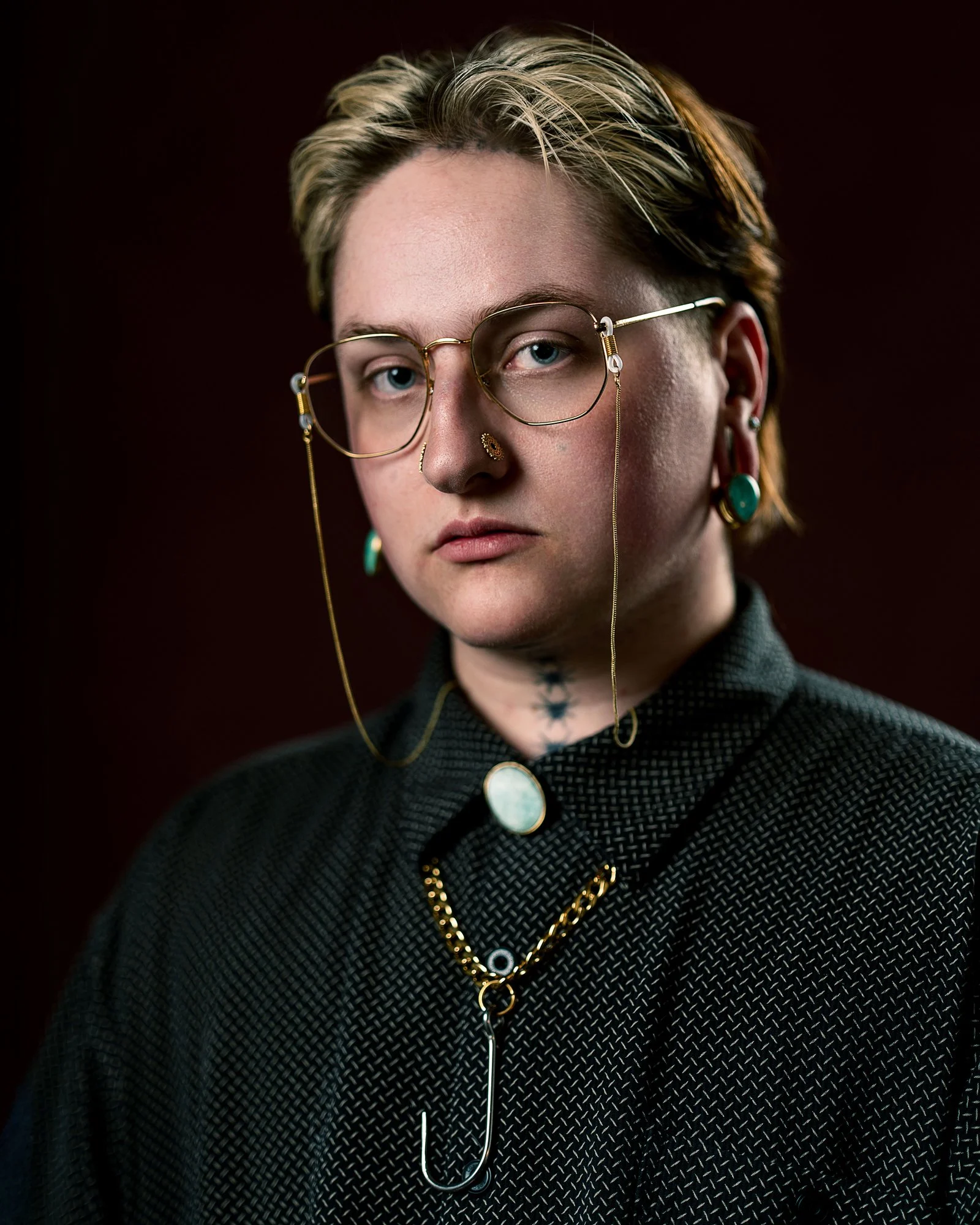 Portrait of person in glasses with chain