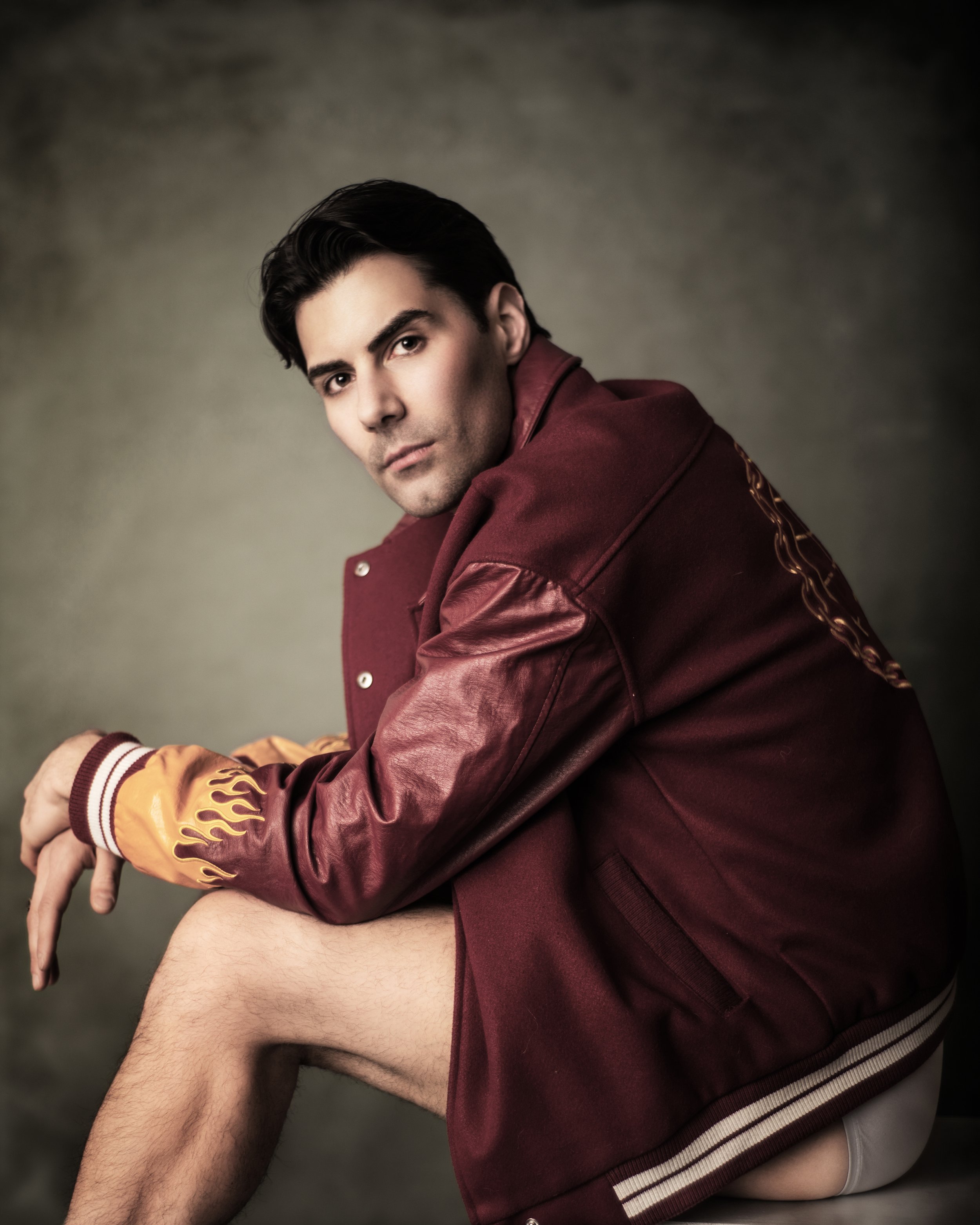Portrait of a man in a red sports jacket and underwear