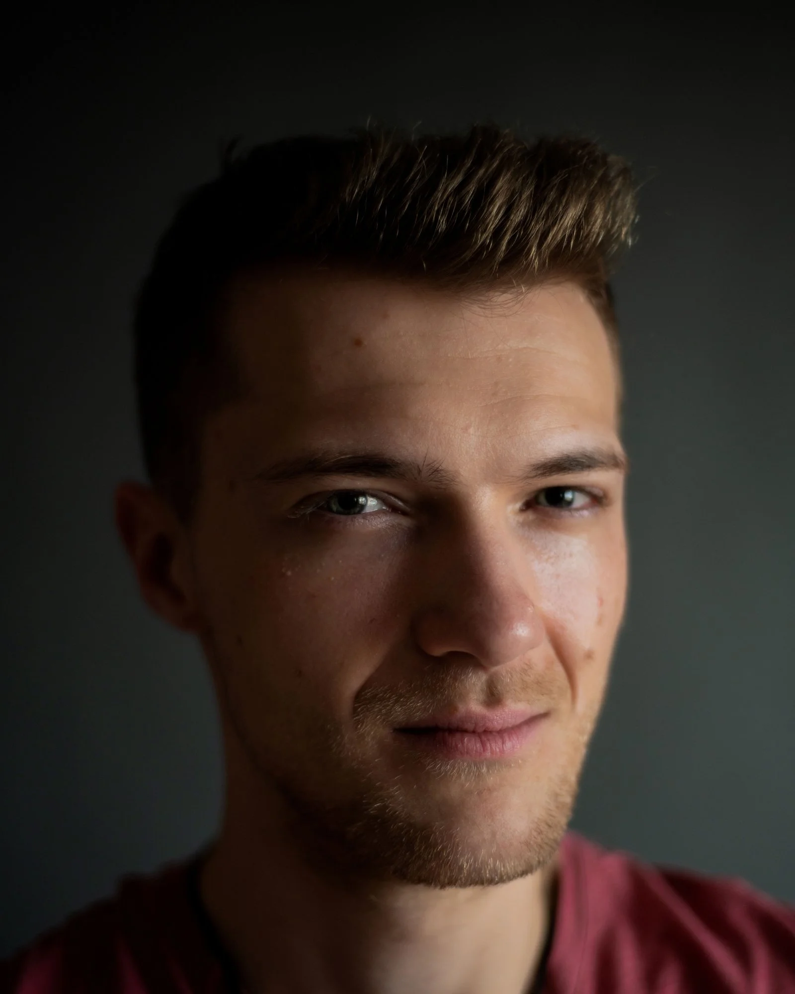 Headshot of man in red shirt