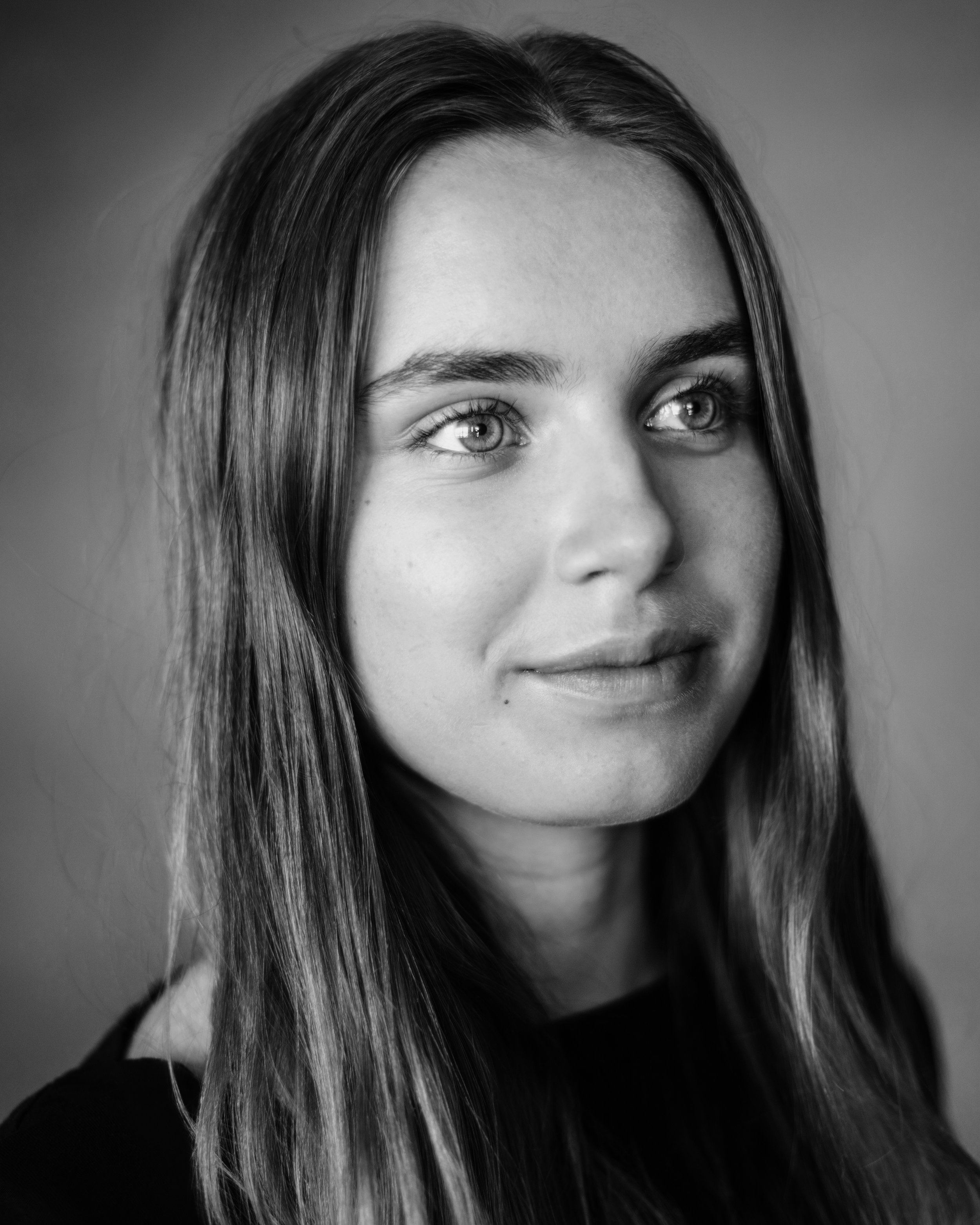 Black and white Headshot of a woman looking off to the side