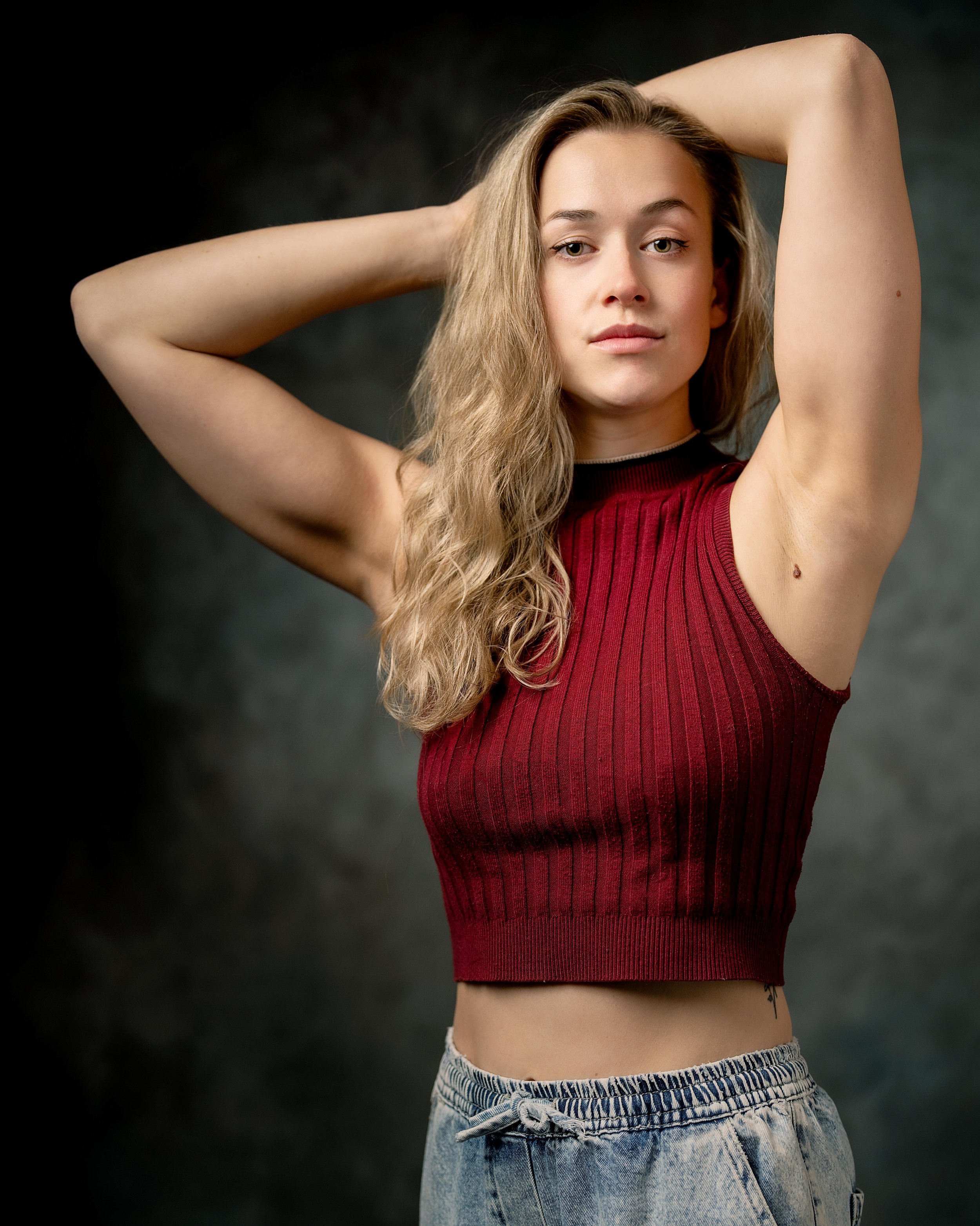 Portrait headshot of female actor in red top and blond hair down