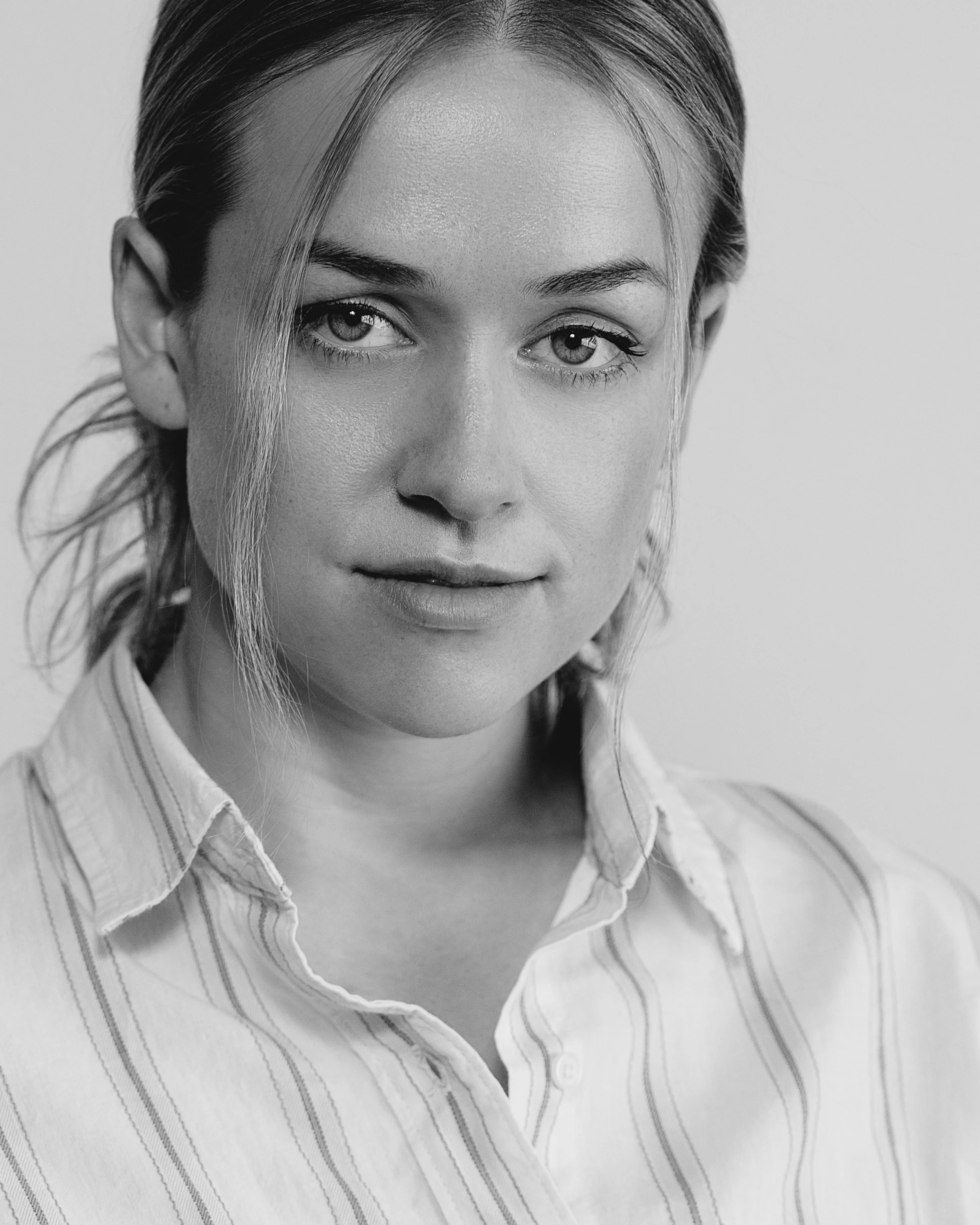 Portrait headshot of female actor in white and black with white stripes