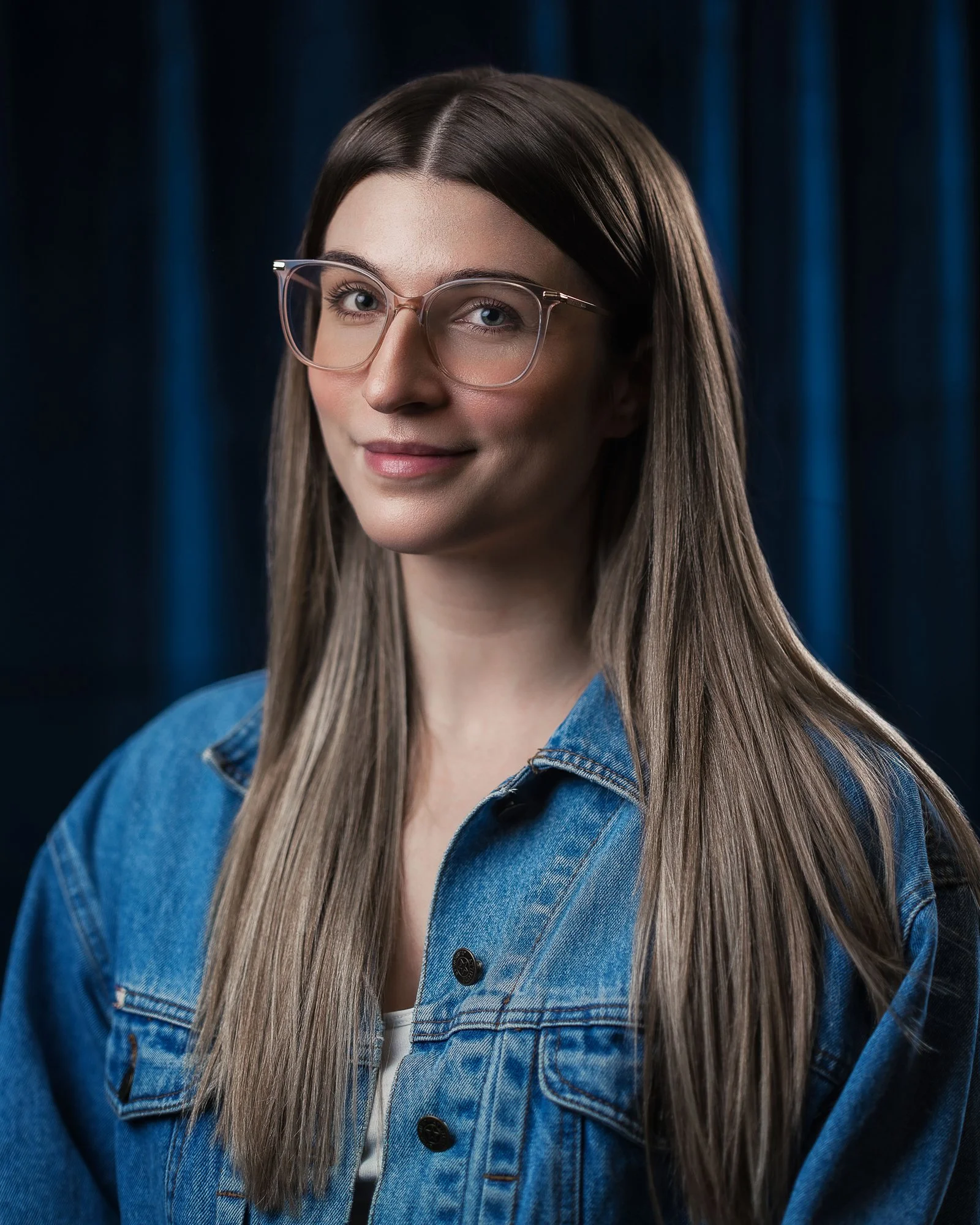 portrait of woman jean jacket glasses