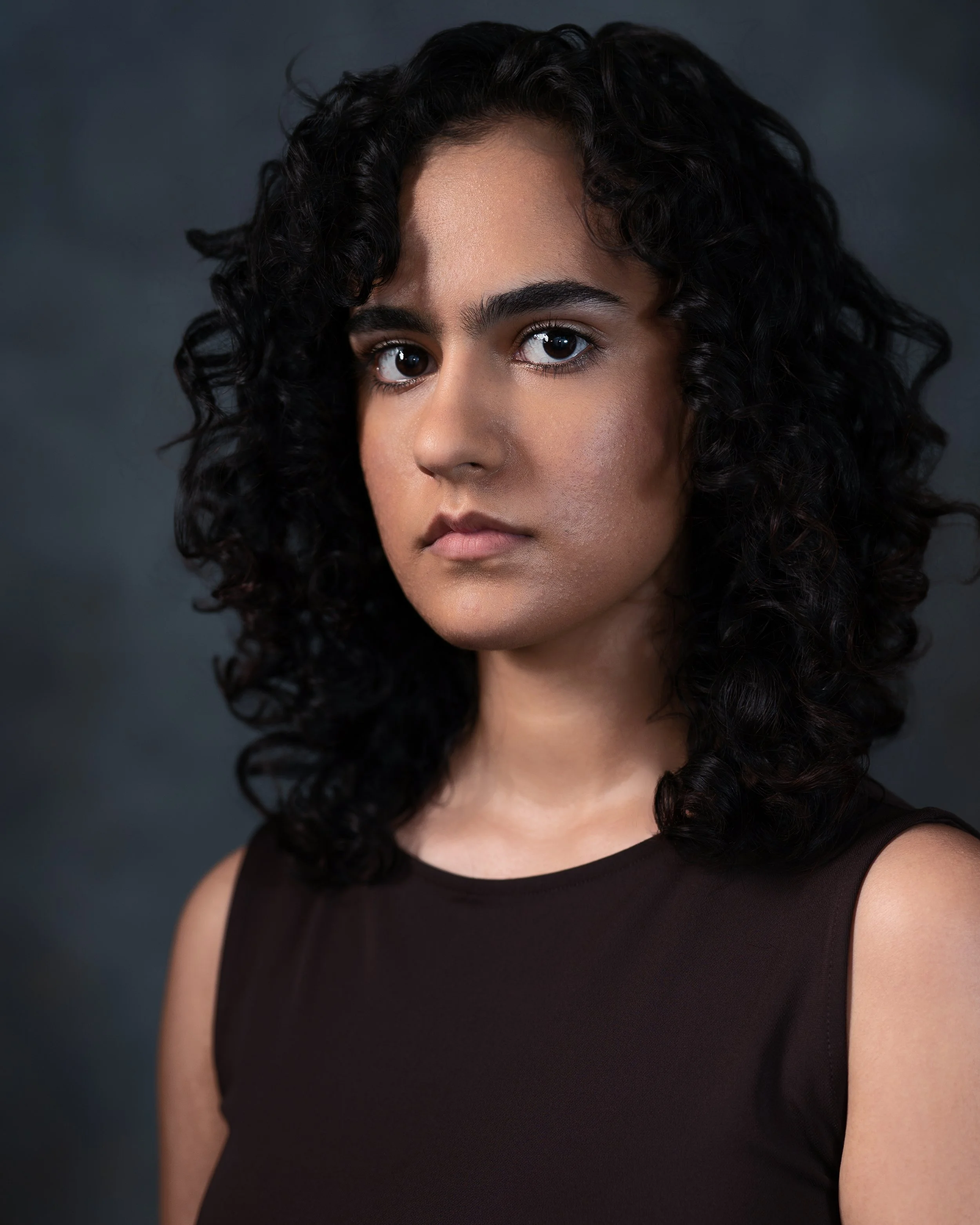 Headshot of brown actor neutral expression