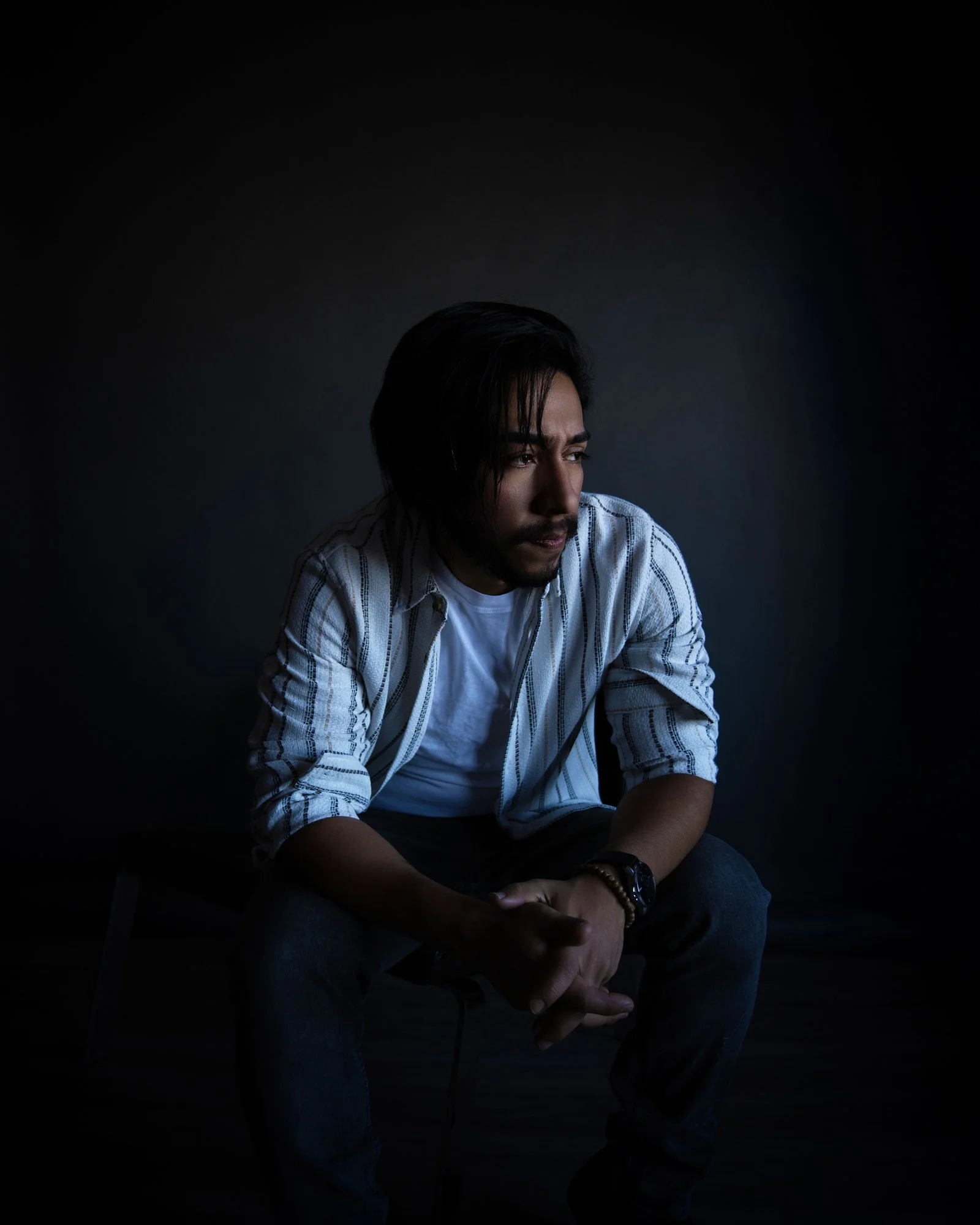 dark moody portrait of man in window light