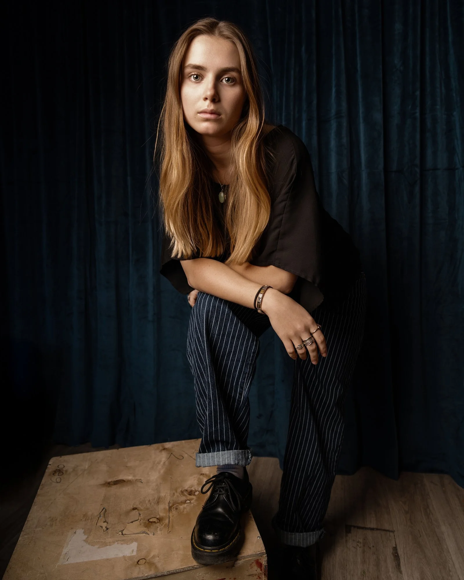Portrait of young woman black shirt and blue striped pants