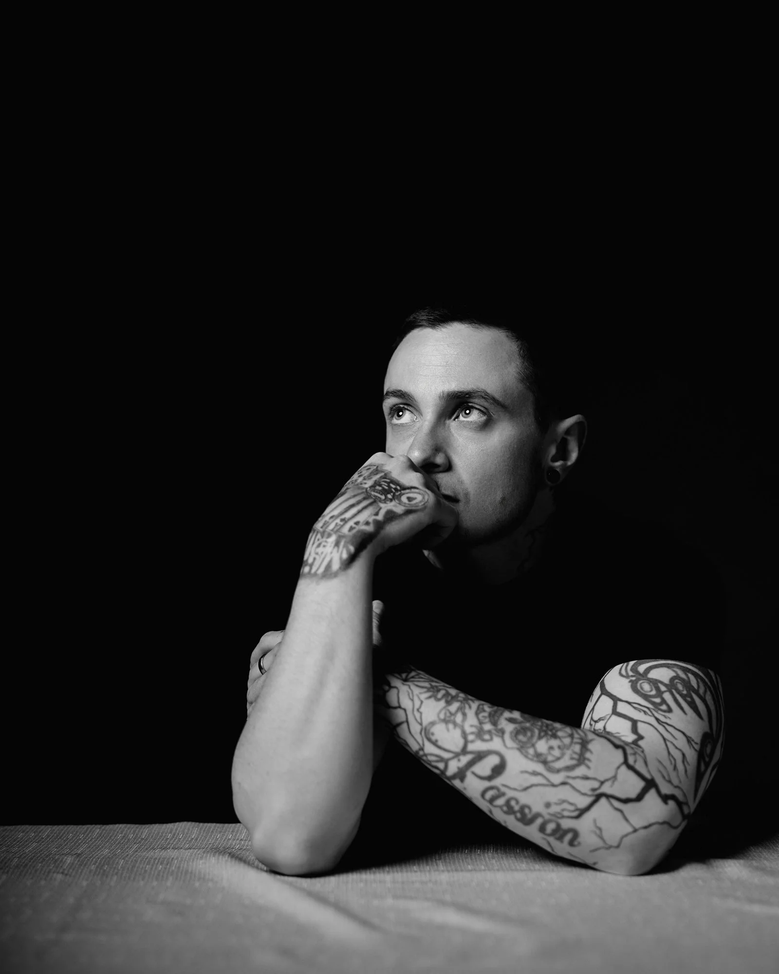black table portrait of man looking out window