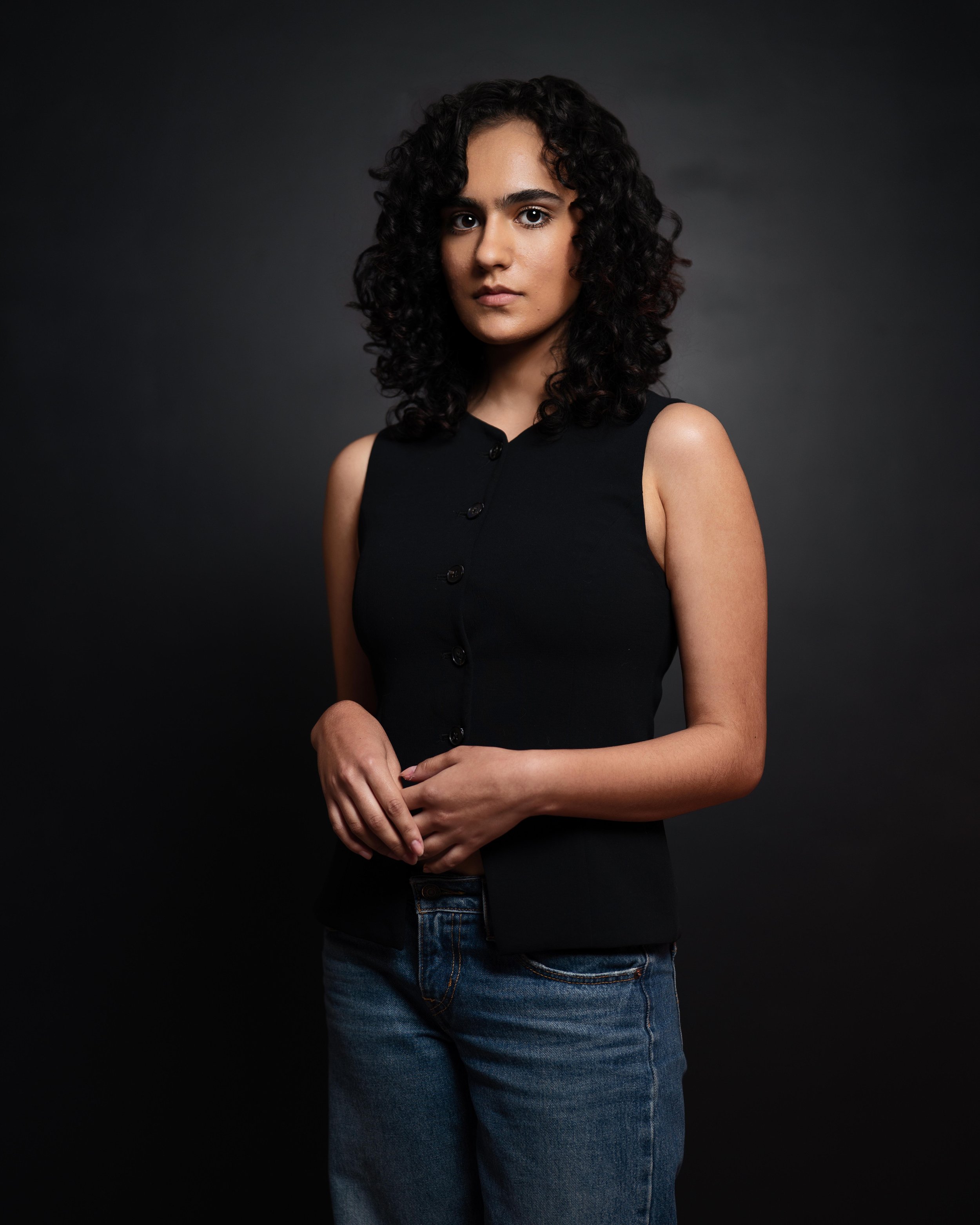 Portrait of brown female actor with black background