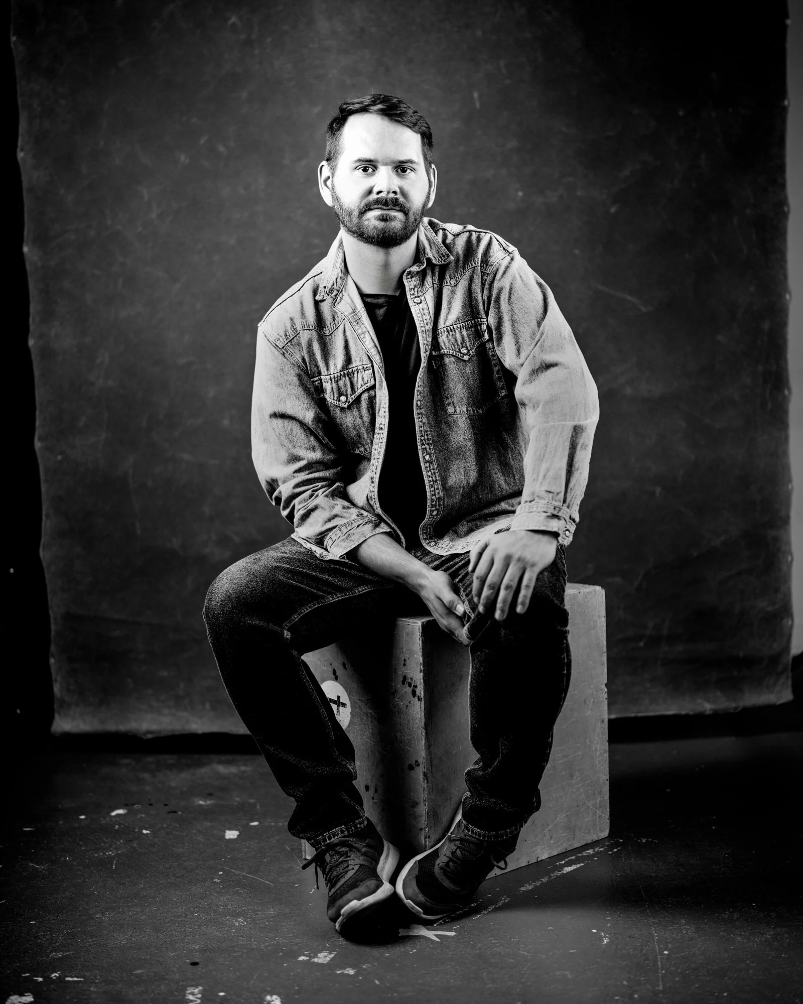 Full length portrait of man on box