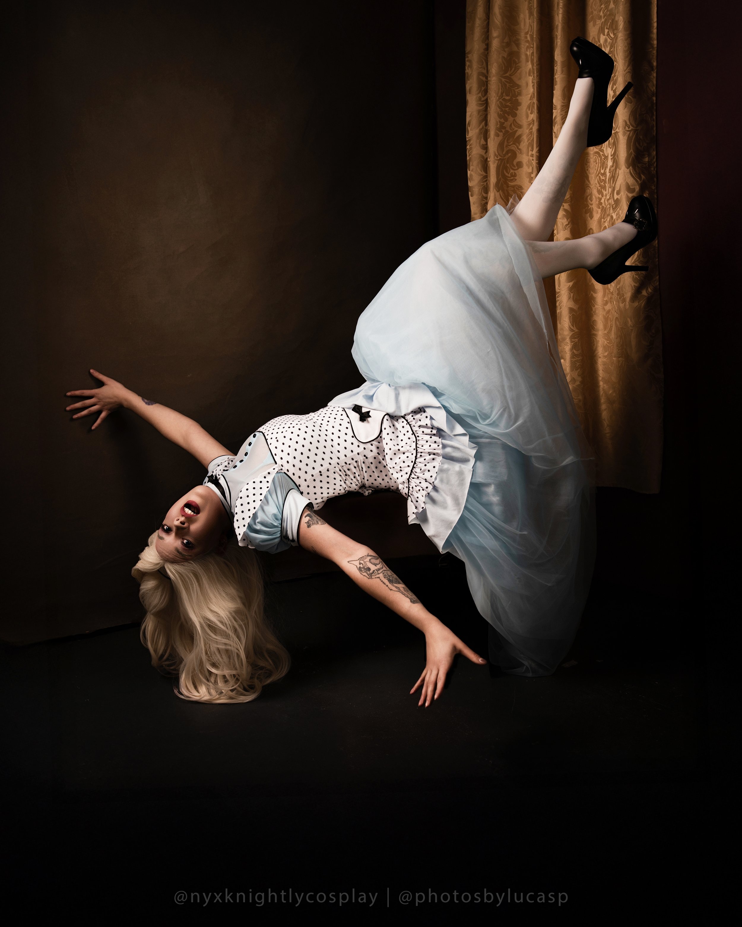 Alice in wonderland falling down the rabbit hole in a blue dress