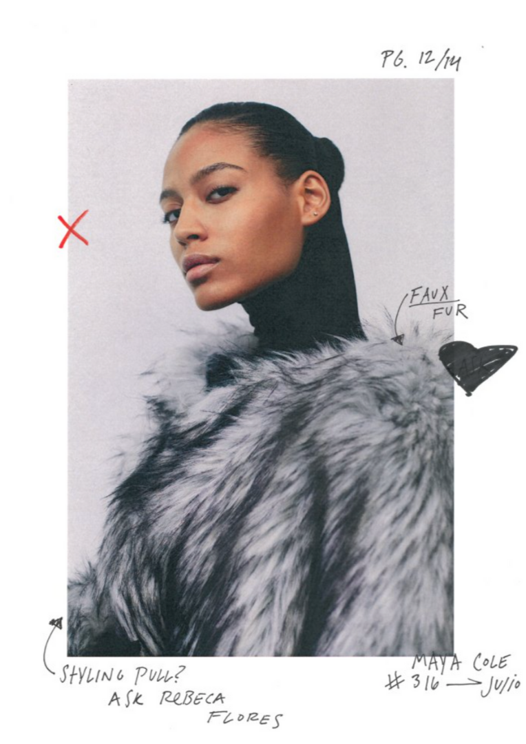 A woman with dark hair in a sleek bun wearing Balenciaga, looking over her shoulder against a plain background. There are handwritten notes and sketches on the photo, including a red 'X', a black heart labeled 'faux fur', and the name 'Maya Cole'.
