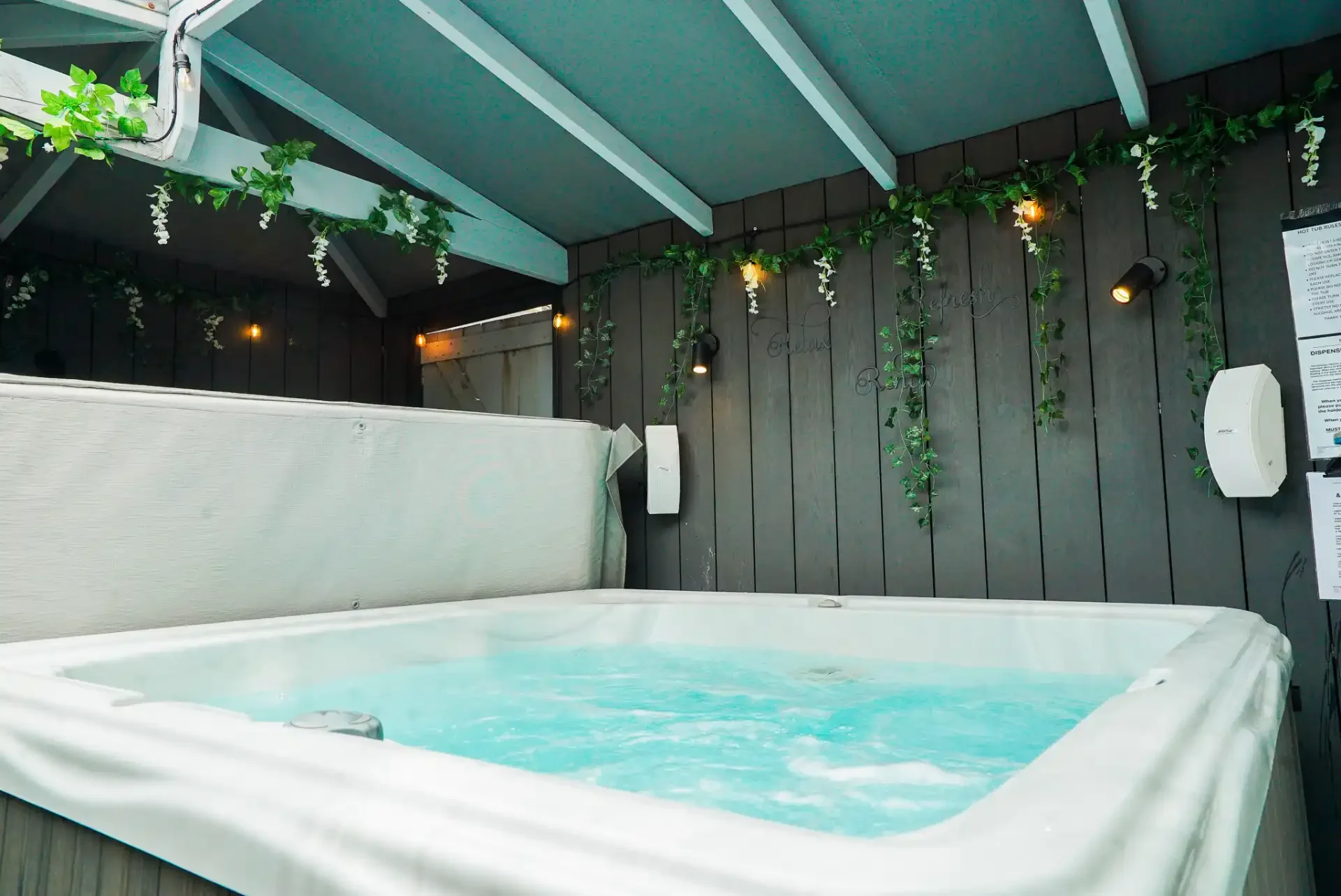 covered-hot-tub-with-string-lights.webp