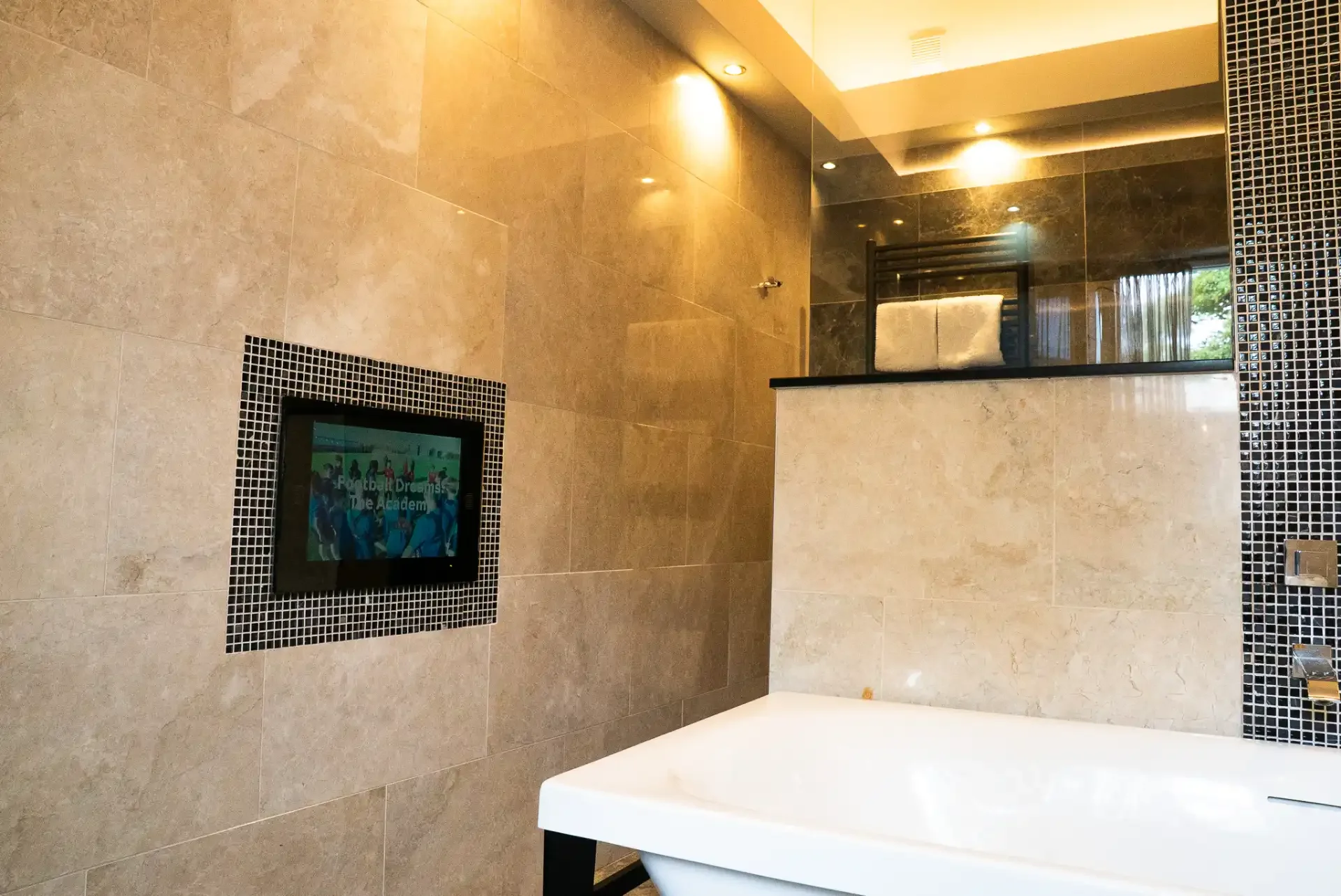 modern-bathroom-with-tv-and-bathtub.webp