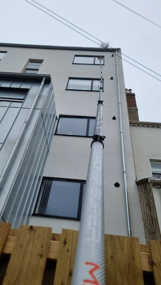 Professional reach-and-wash window cleaning on a multi-storey building, Canterbury