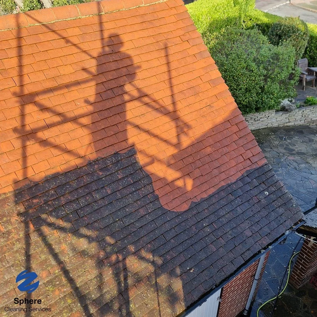 Before and after cleaning during a roof cleaning job from scaffold showing moss and algae removal on red tiles — Sphere Cleaning Services