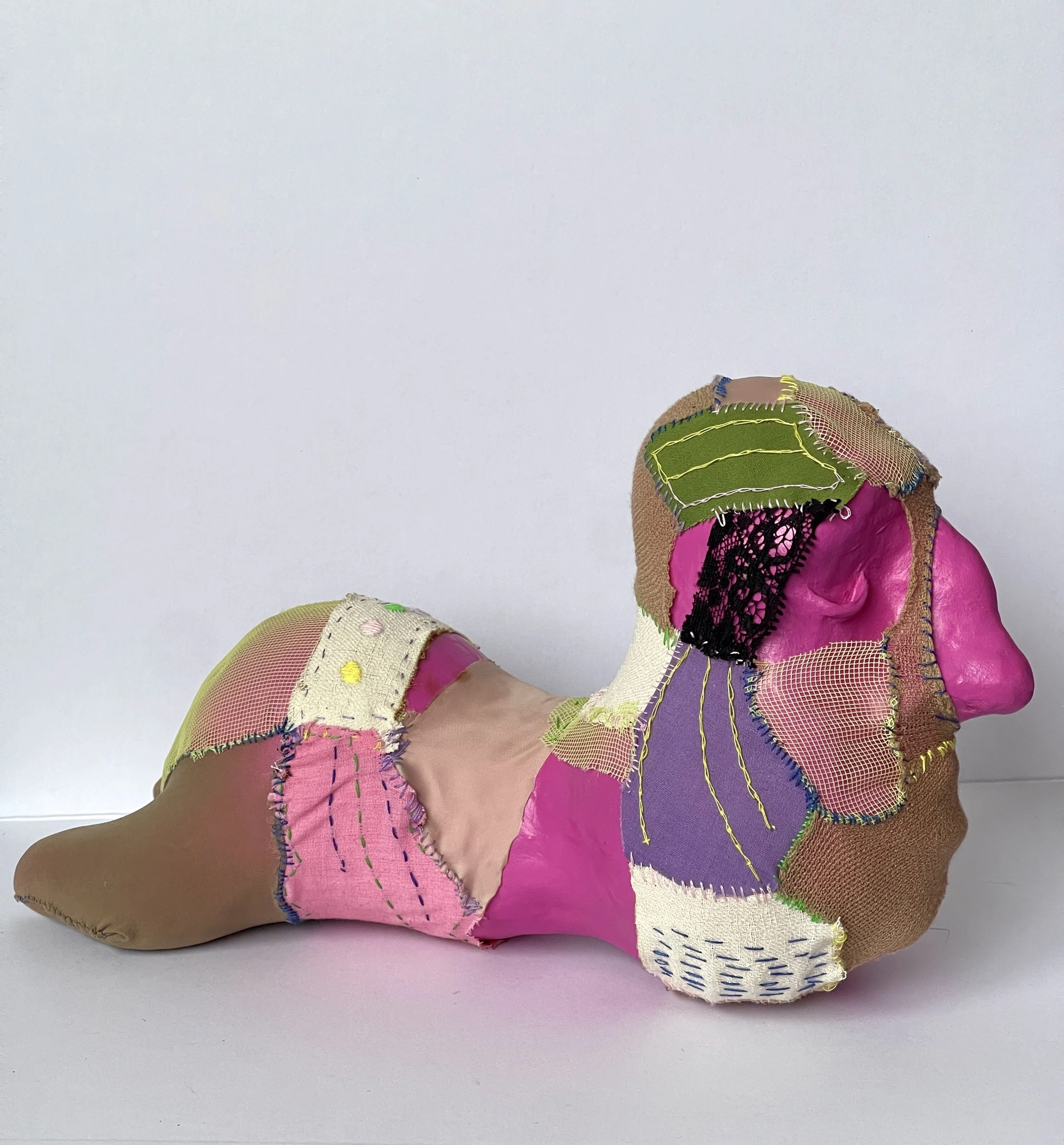 Abstract illustration of a creature with multiple faces, horns, and limbs, overlaid with the text 'Work in progress' in bold pink and purple font.