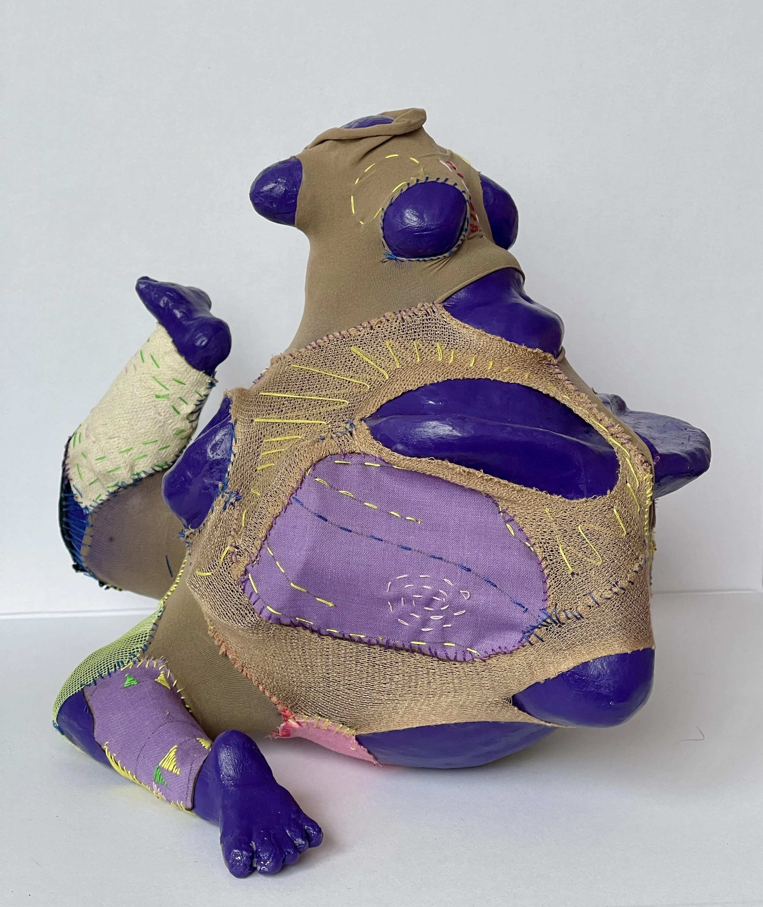 A colorful abstract painting of a figure with vibrant shades of purple, green, and blue, sitting with arms and legs tangled, set against a bright pink background.