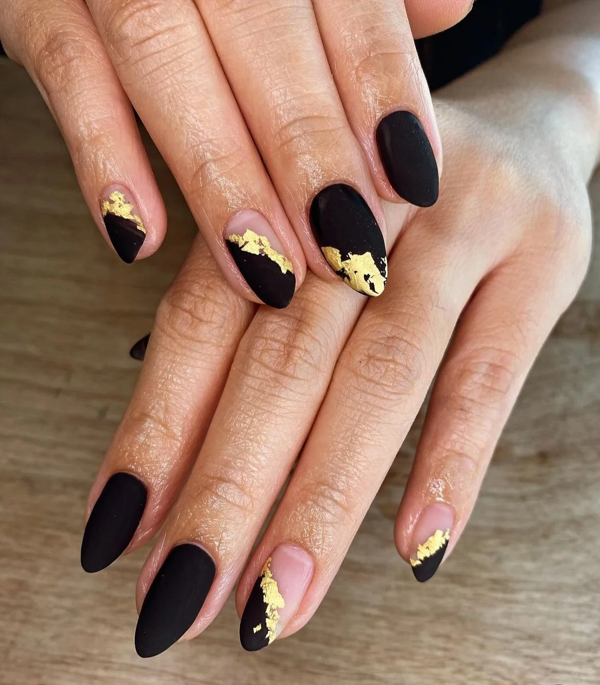 Black nails with gold foil accents