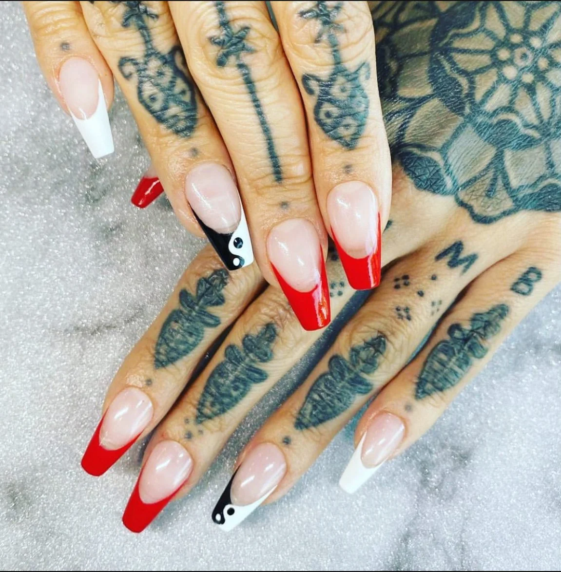 Red french tip square nails with yin yang on pointer and classic white tip on pinky