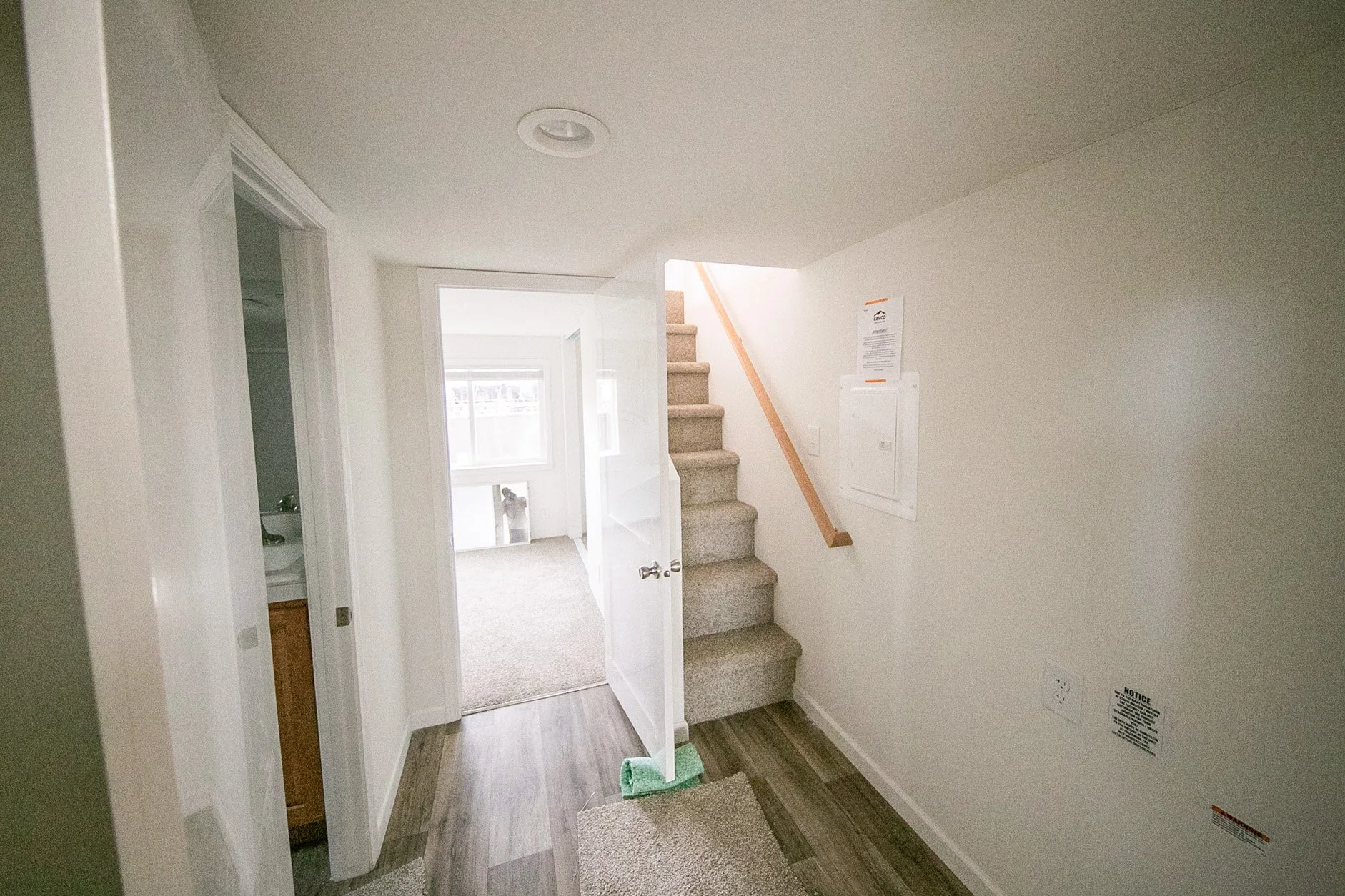 Hallway with stairs leading up to loft