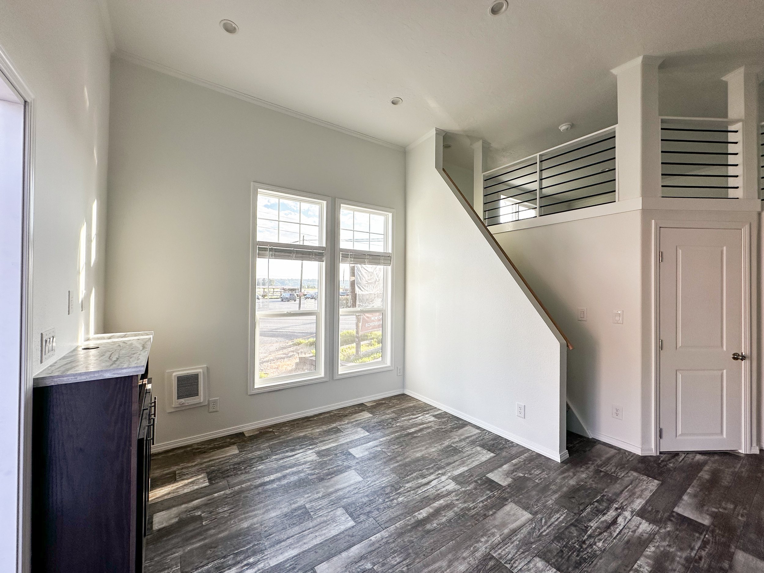 Lofted Ponderosa living room with stairwell and entertainment center