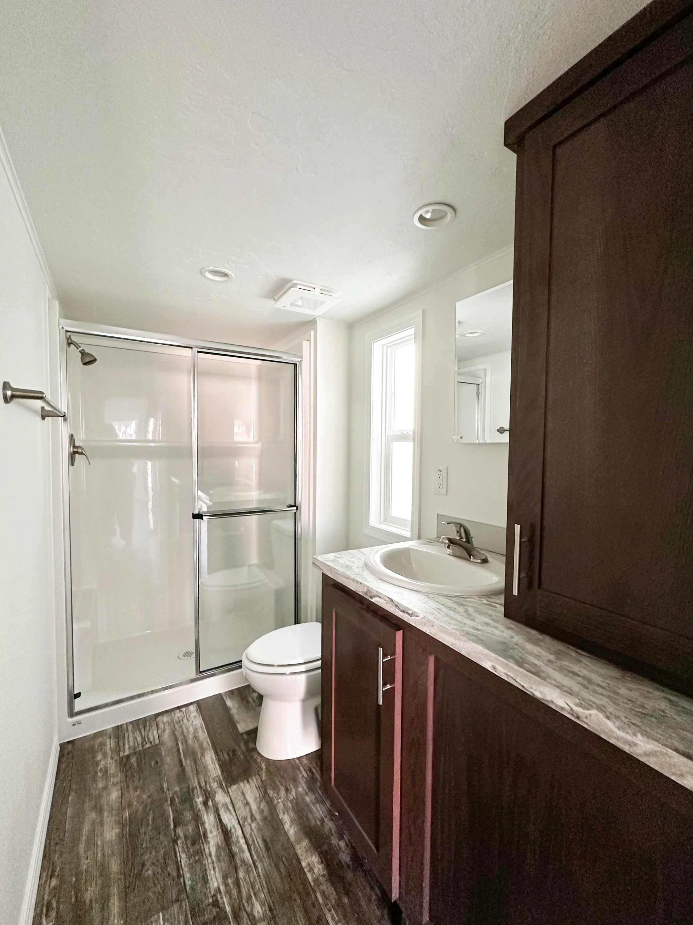 Lofted Ponderosa bathroom with walk-in shower and cabinetry