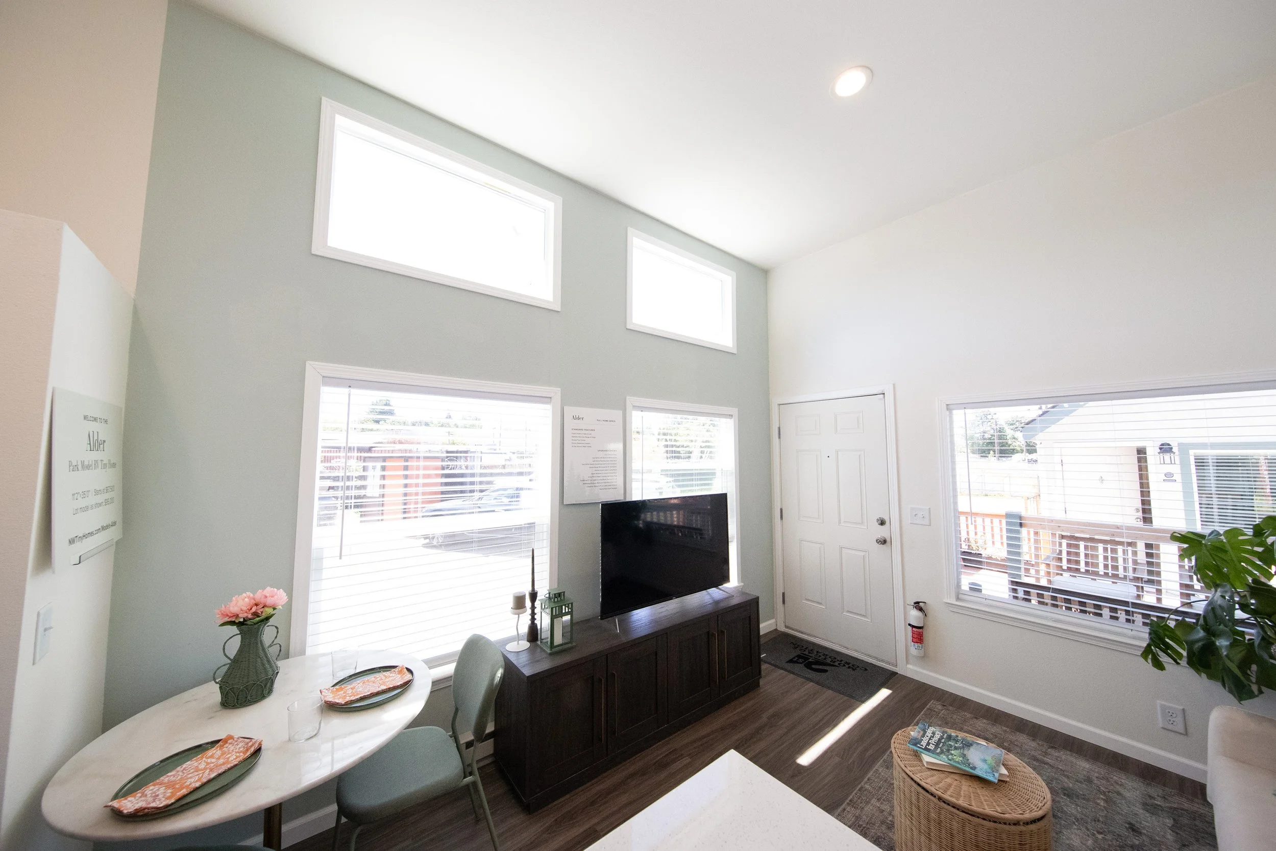 Portland Alder model living room/dining room wall with painted accent wall in Rainwashed