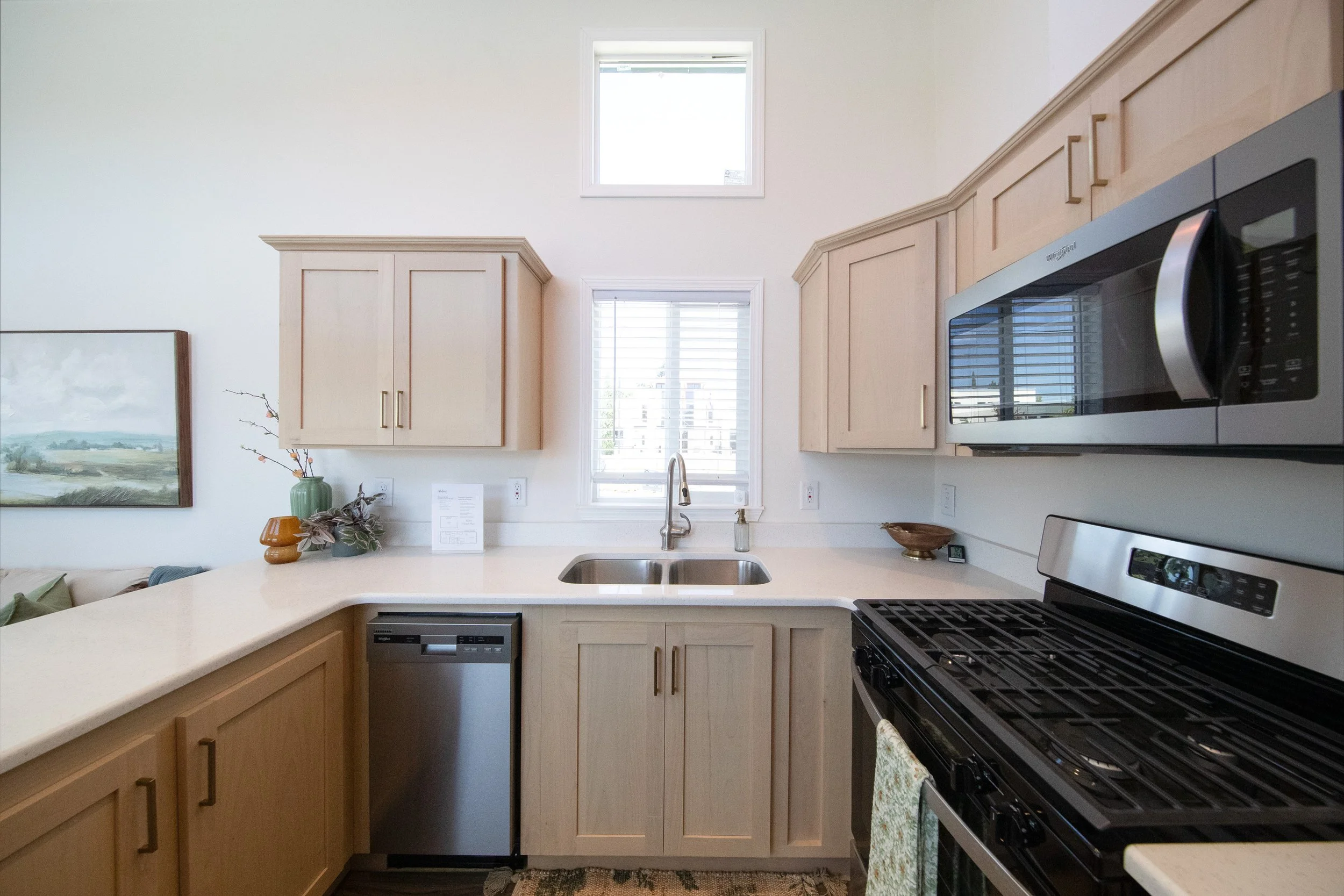 Portland Alder model kitchen with Snow Plank cabinets, sink, and 18 inch dishwasher