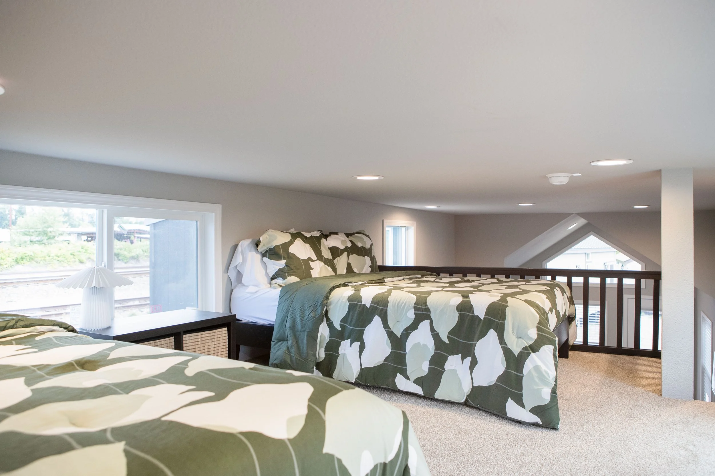 Snohomish Hemlock model with two double beds and black railing