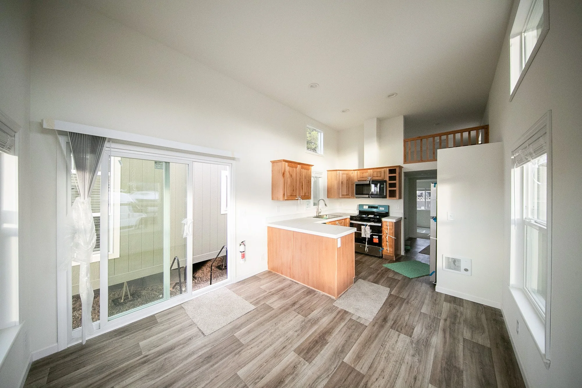Living room view into kitchen and sliding glass door entry