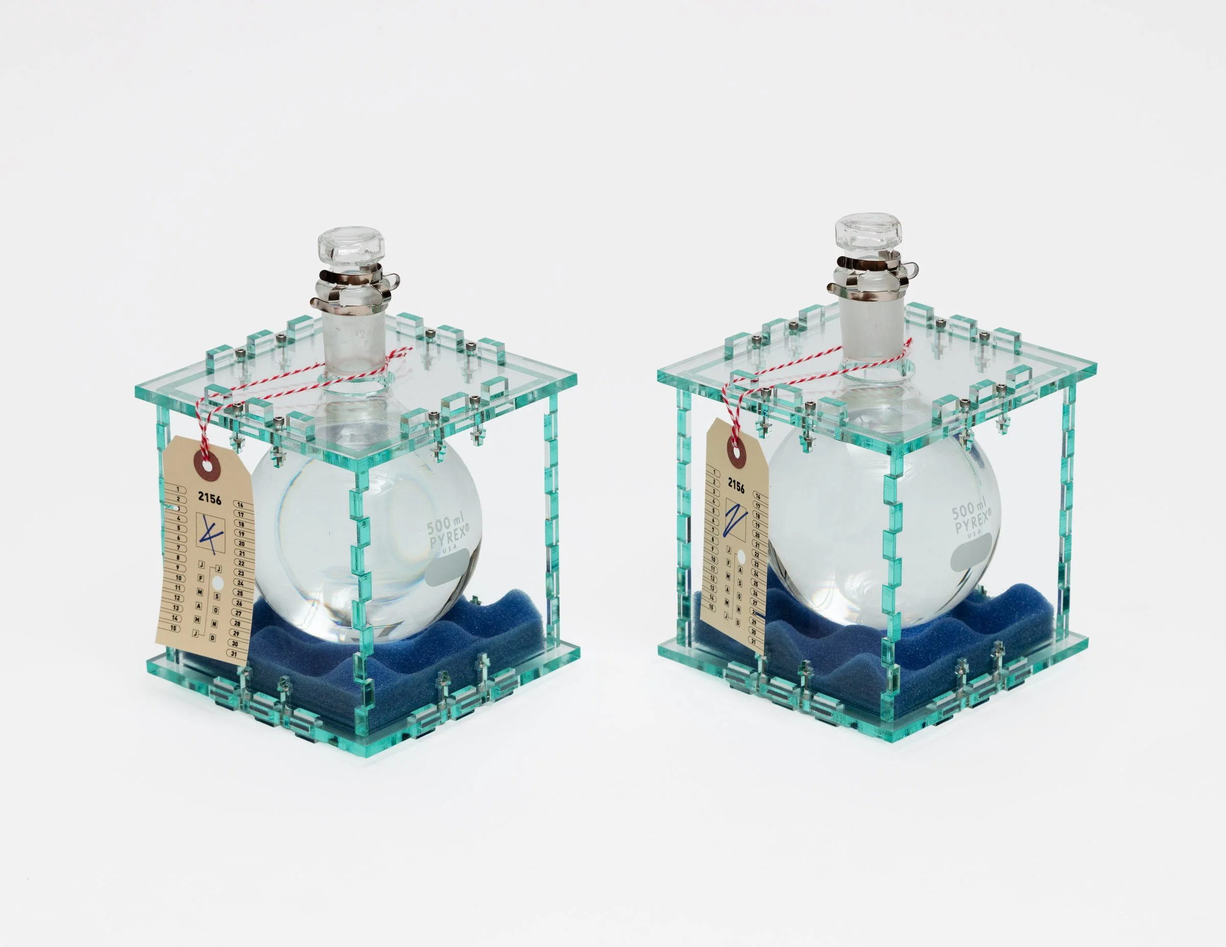   Water Scrips (ca. 2156),   2025 Fresh water, manila paper, plexiglass, polyester string, polyurethane foam, Pyrex round-bottom flasks, stainless steel Dimensions variable  Photo by LF Documentation