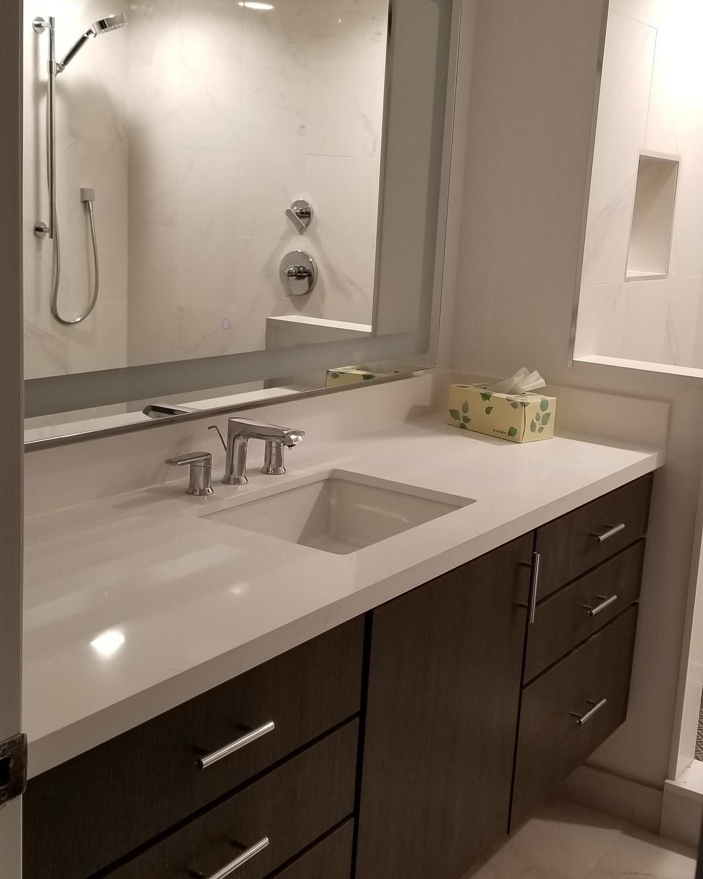 Brand new bathroom in a condo featuring floating vanity, floor to ceiling storage cabinet and a walk-in shower.