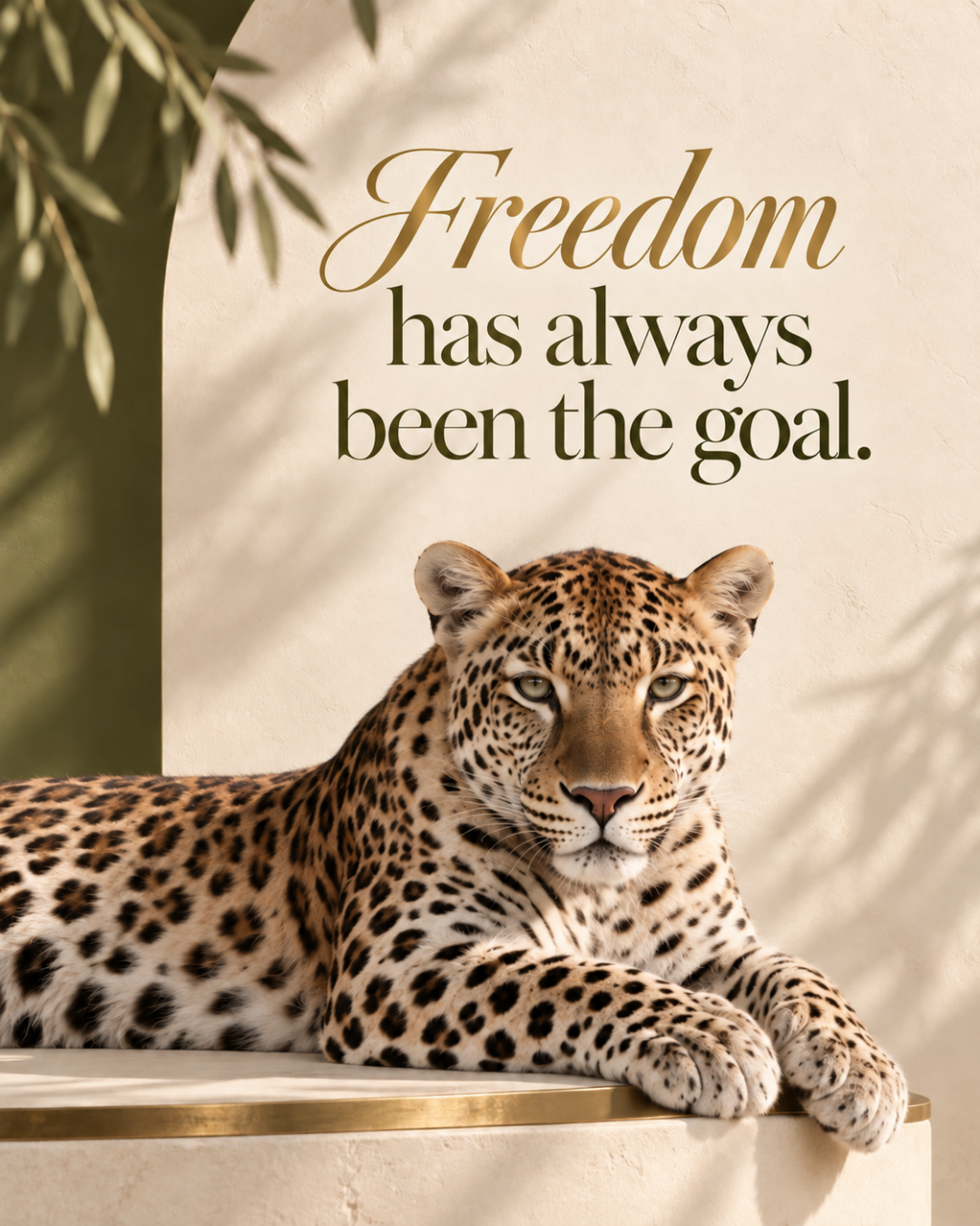 A leopard lying on a table in front of a wall with the quote 'Freedom has always been the goal.'