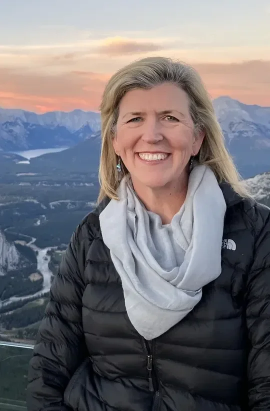 Vida Killian smiling outdoors in the mountains
