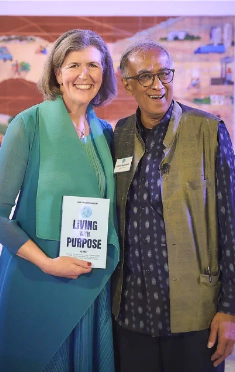 Vida with Dr. Akhtar Badshah holding Living with Purpose