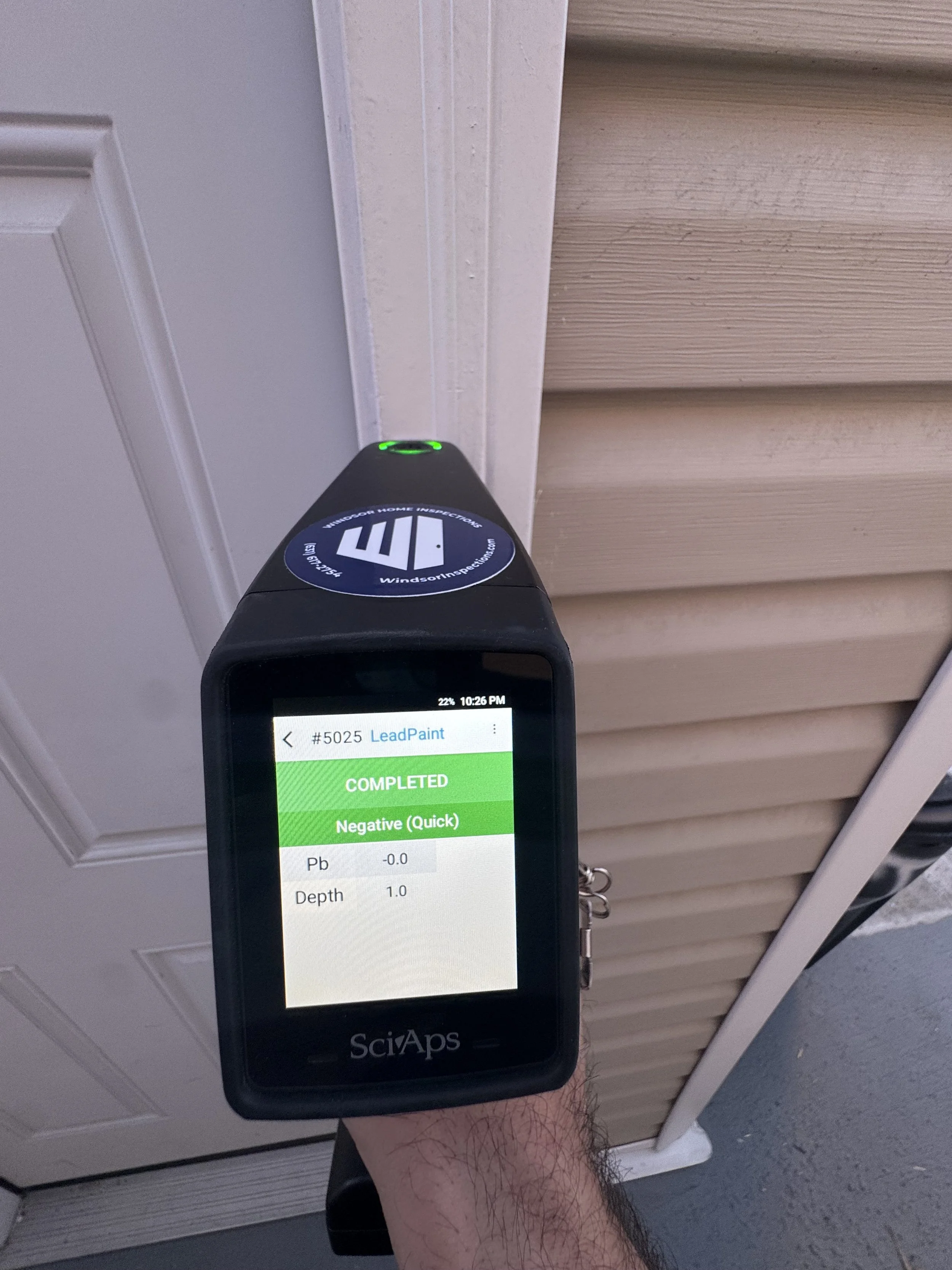 Our XRF lead-based paint tool will quickly display a completed lead paint test result. In this instance, it is showing a 'Negative' result on the house exterior, which means lead was not detected.