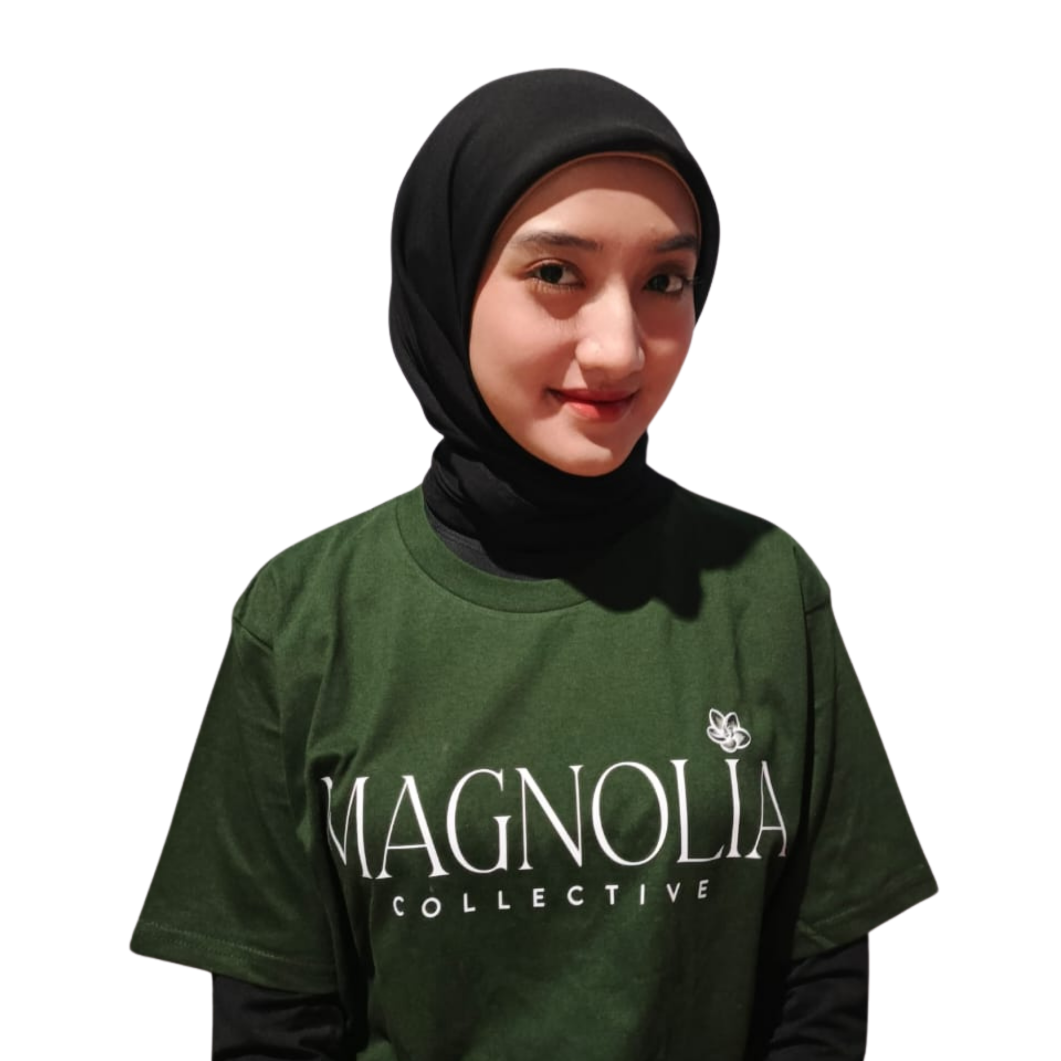 A young woman wearing a black headscarf and a green Magnolia Collective t-shirt, smiling slightly, against a plain white background.