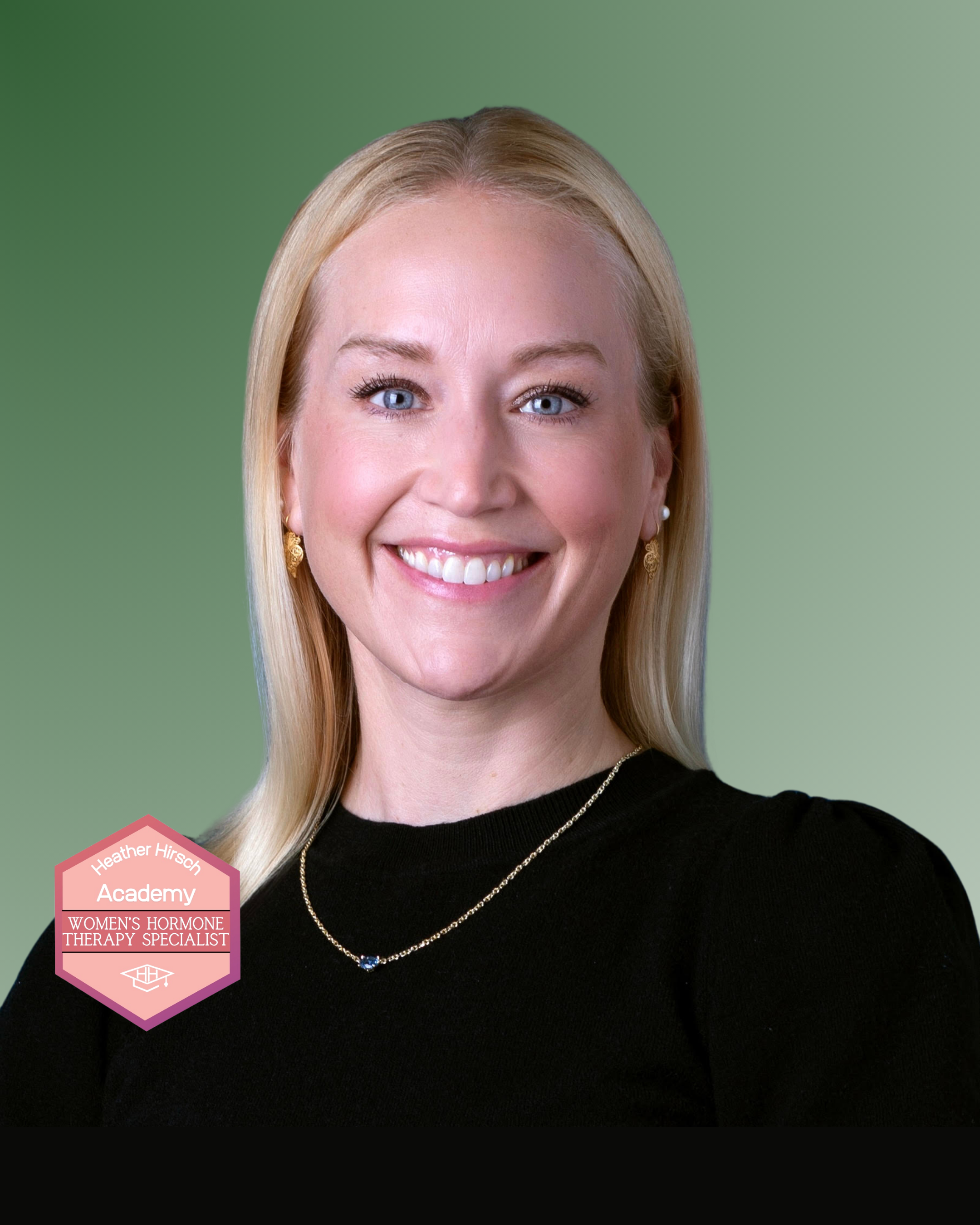 Portrait of a smiling woman with blonde hair, wearing a black top, pearl earrings, and a gold necklace with a small blue pendant. The background is green. There is a pink badge on her shoulder with the text 'Heather Hirsch Academy Women's Hormone Therapy Specialist'.