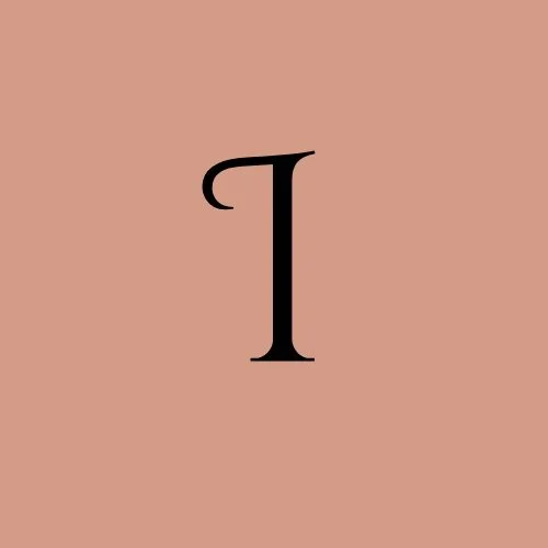 A stylized black letter 'I' on a pink background.