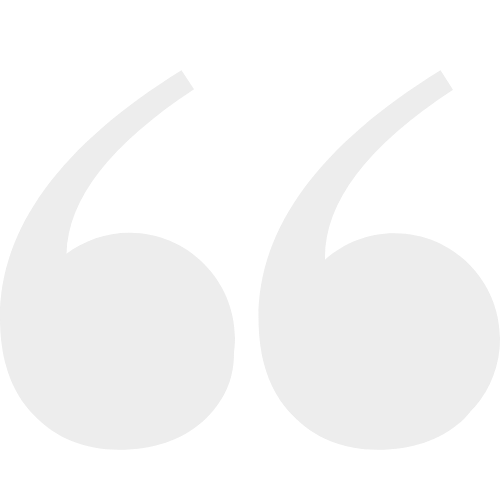 Close-up of a large, gray quotation mark symbol.