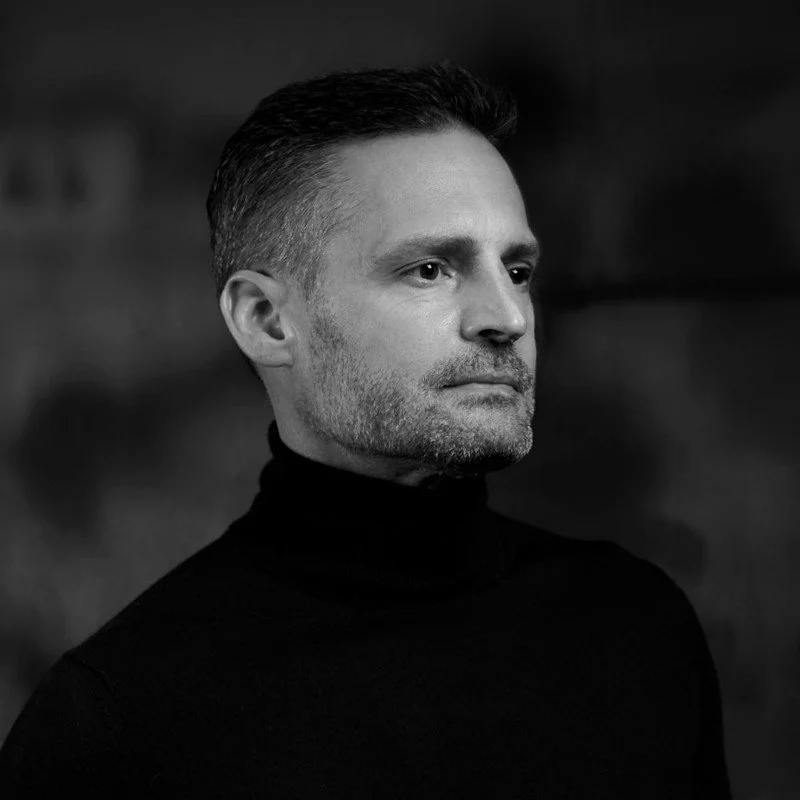 Black and white portrait of a man in a turtleneck