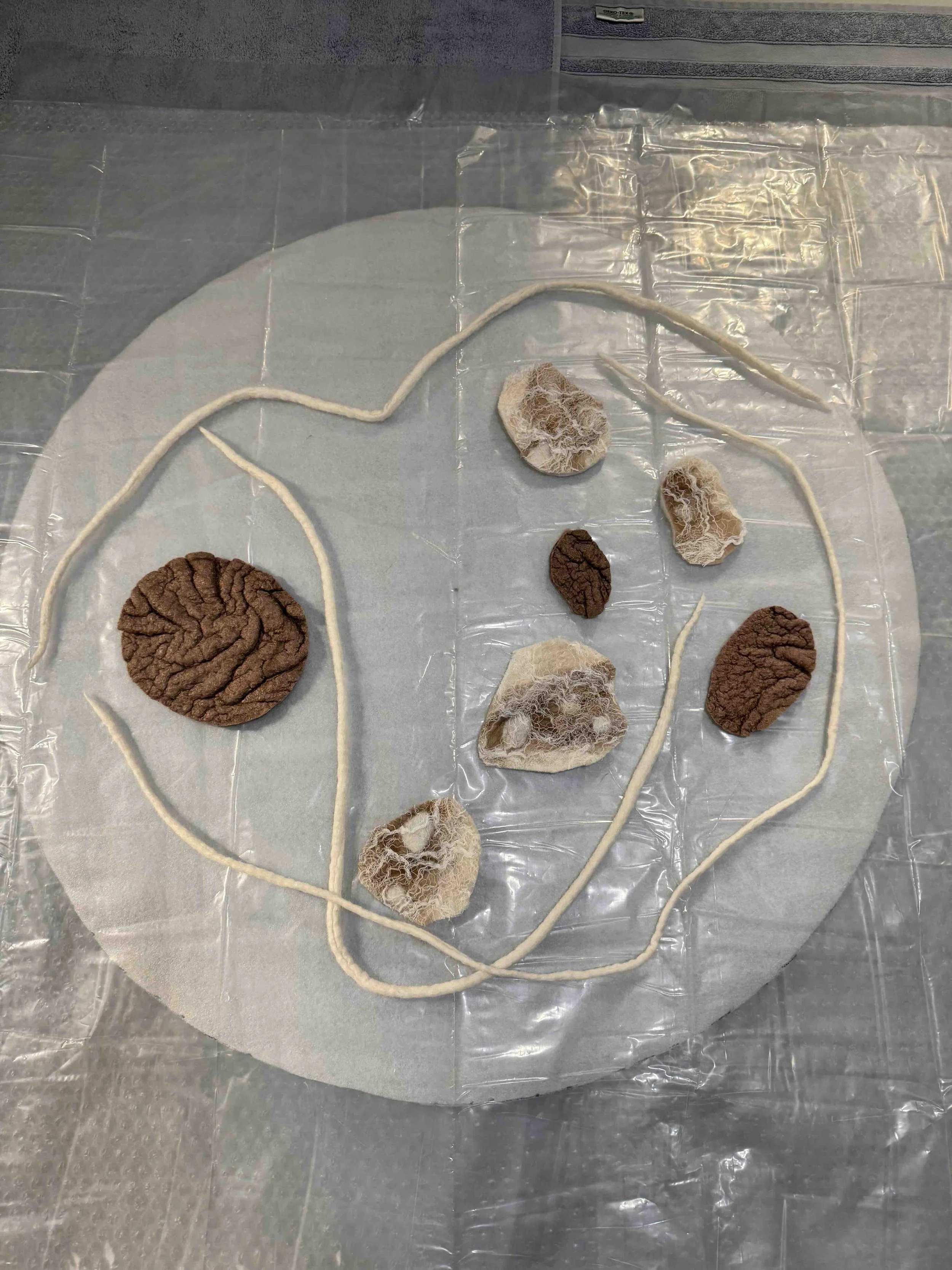 Plotting and planning with felted cords and design elements