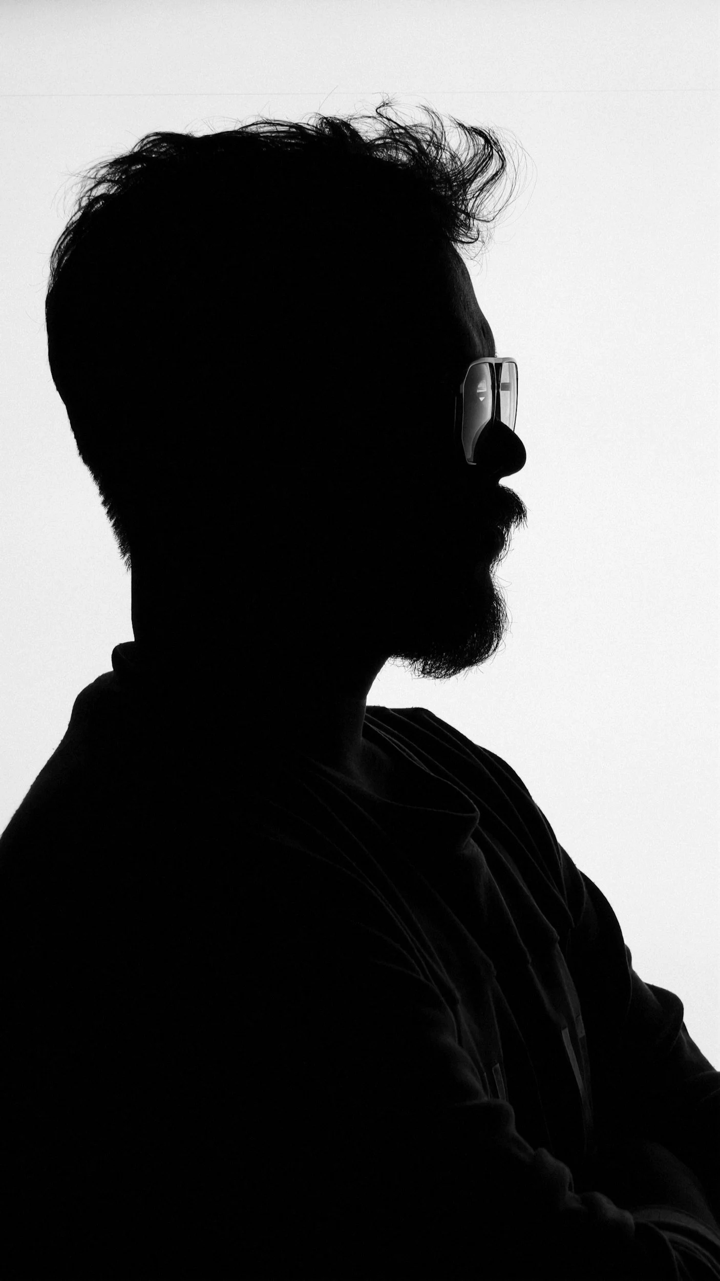 Stark profile silhouette of a man in glasses. Artistic character headshots in Southend by Matt Daley.