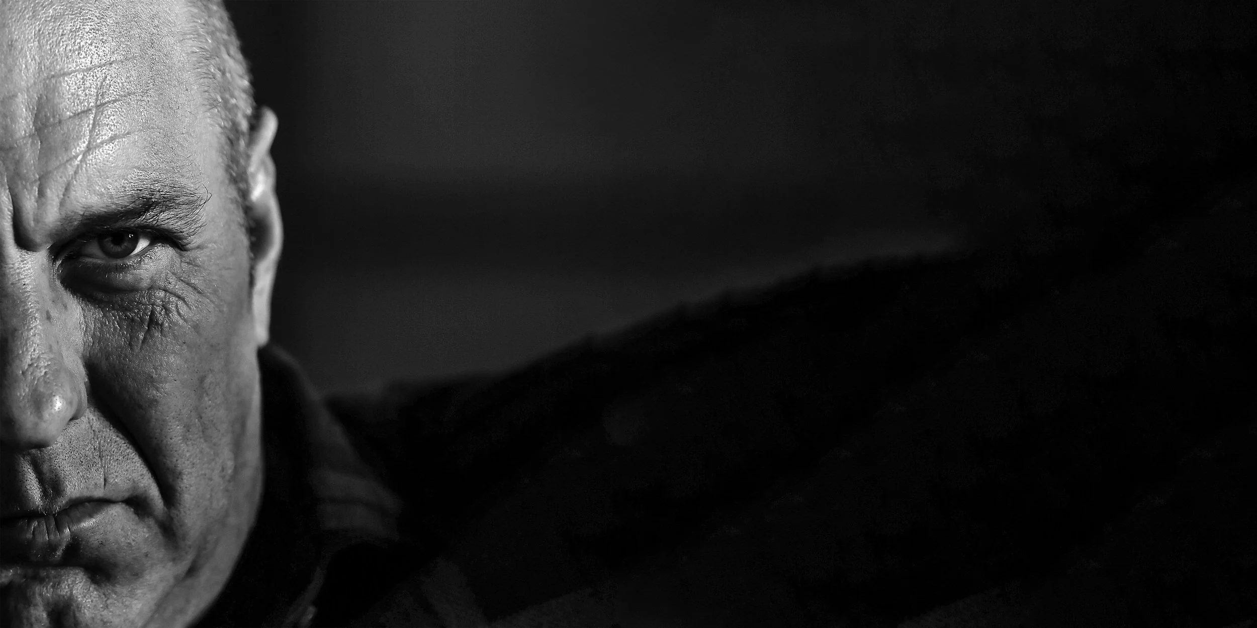 Intense black and white male character headshot. Professional theatrical photography in Essex by Matt Daley.