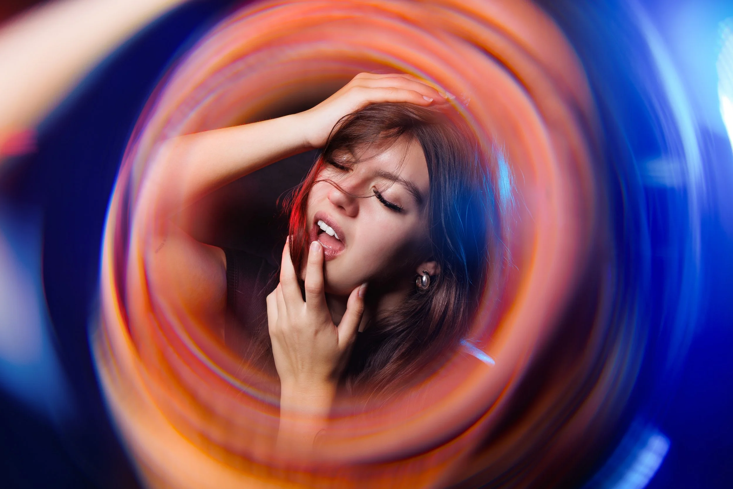 Artistic lighting portrait of model kelseymodels.x featuring creative red and blue portal lens filter effects.