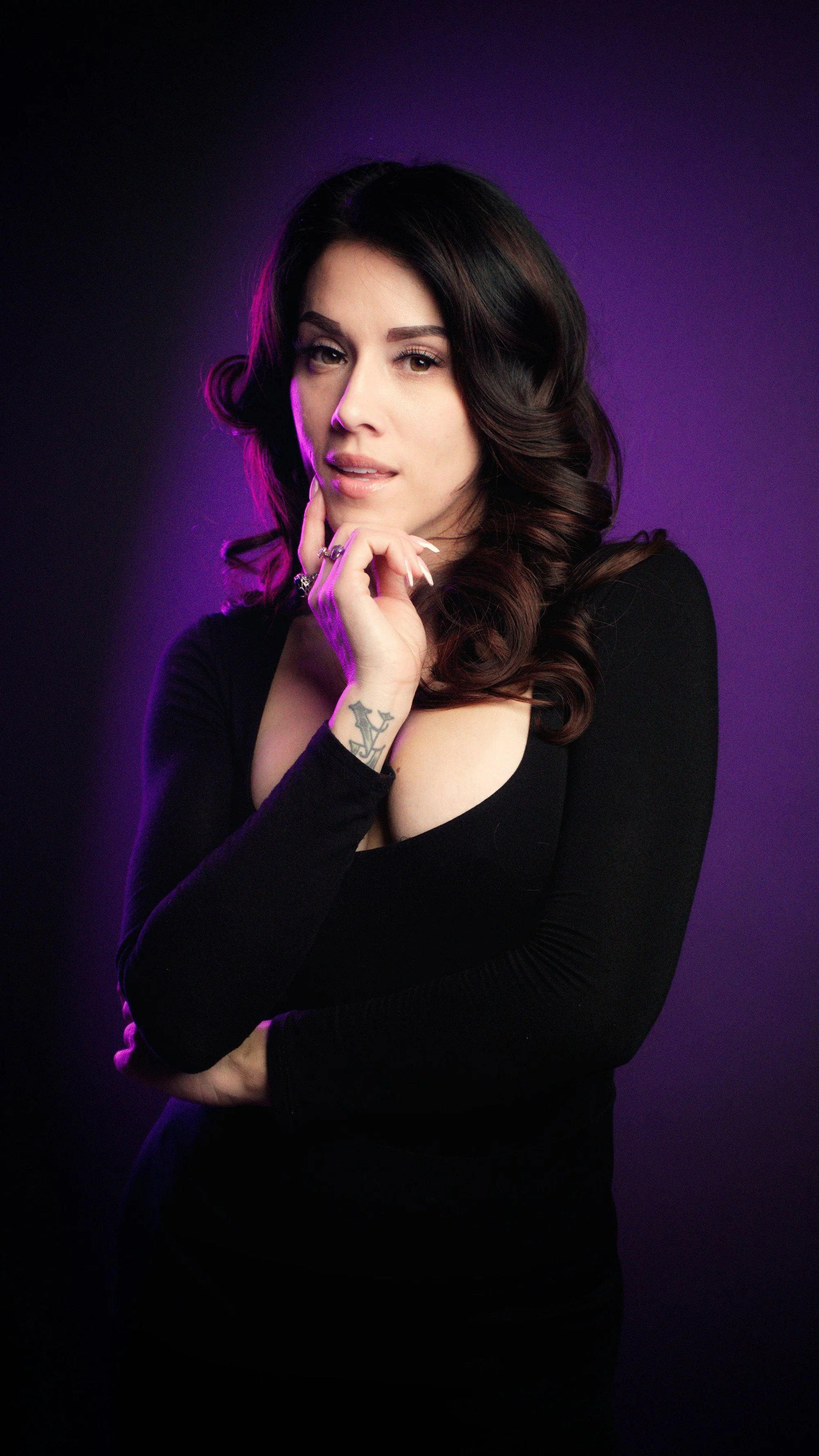 Bold female portrait with purple rim lighting. Professional promotional headshots in Essex by Matt Daley.