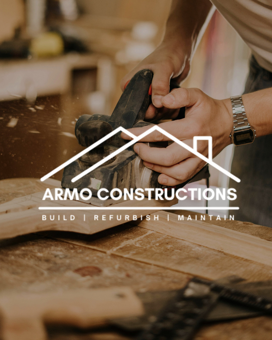 A person with a silver watch uses a hand planer to smooth a piece of wood in a woodworking shop. The image promotes Armo Constructions, a company that builds, refurbishes, and maintains.