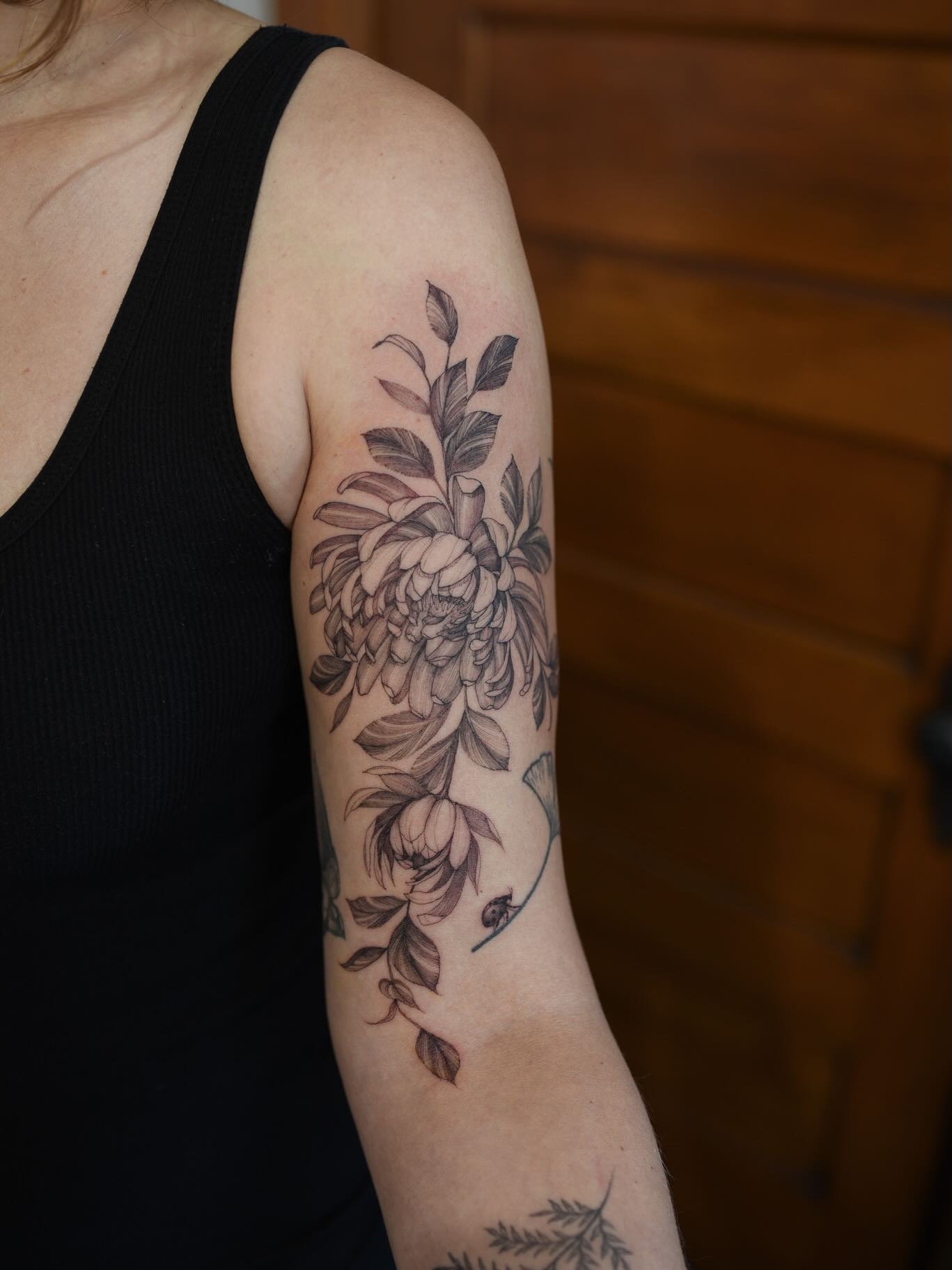 chrysanthemums dancing down her arm and a lil ladybug that landed on a ginko leaf (not my work) 

#finelinefloral #ohiotattooers