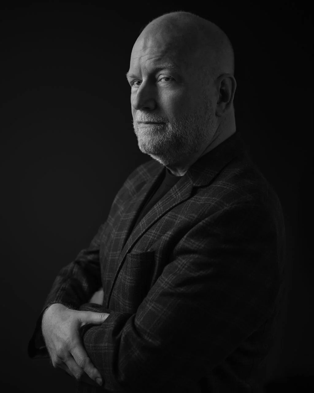 Editorial portrait of Canadian military veteran and political strategist, Mark Towhey wearing a dark plaid blazer.